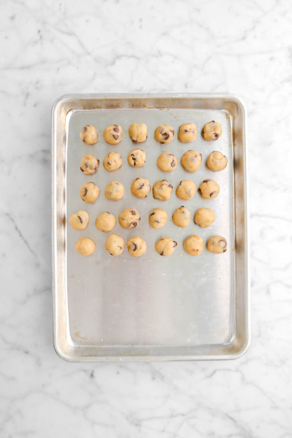 cookie dough balls on small sheet pan