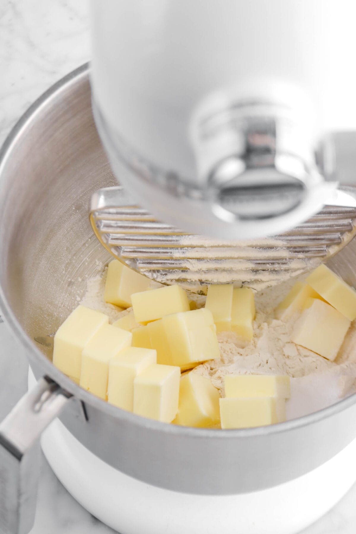 sliced butter and flour in stand mixer