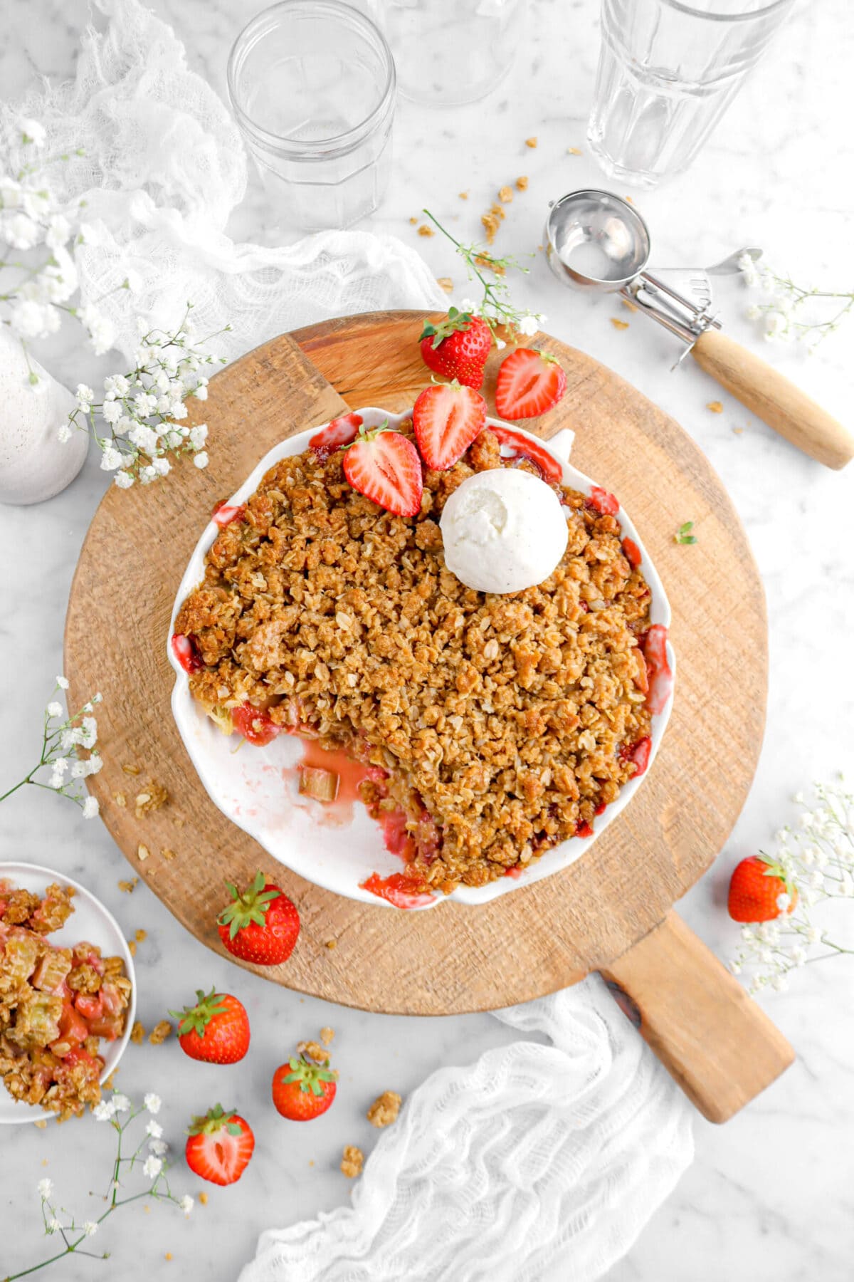 overhead shot of strawberry crisp in pie pan with serving missing
