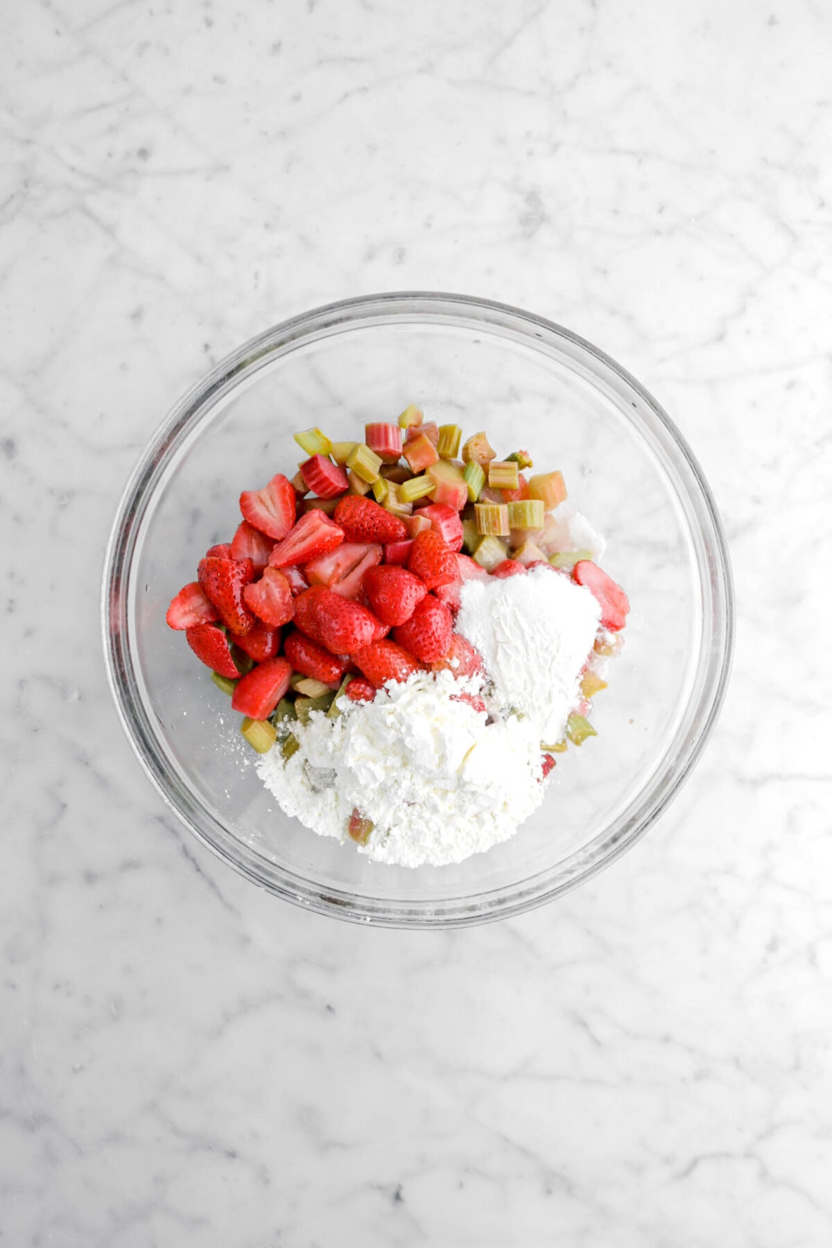 strawberries, rhubarb, cornstarch, and sugar in glass bowl