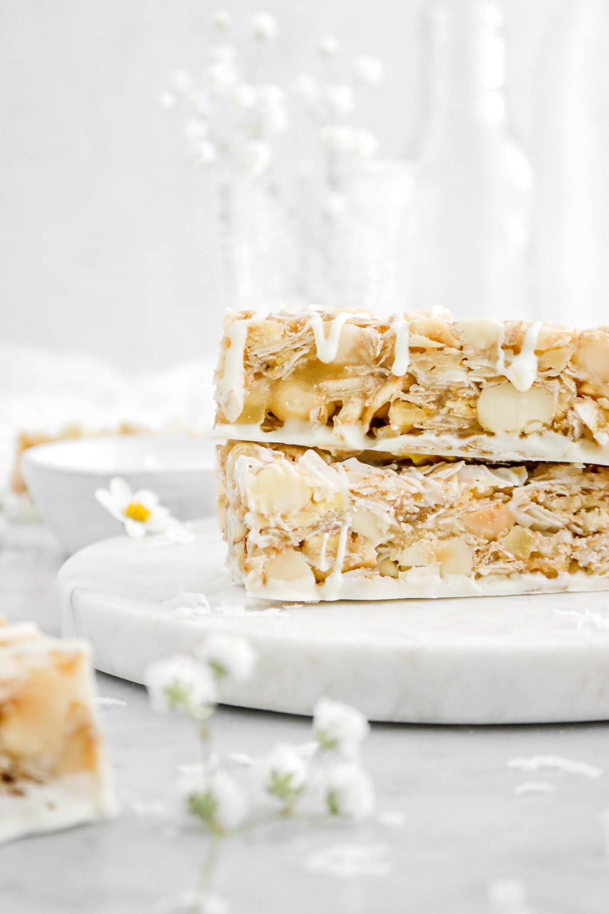 close up of two stacked granola bars on marble plate