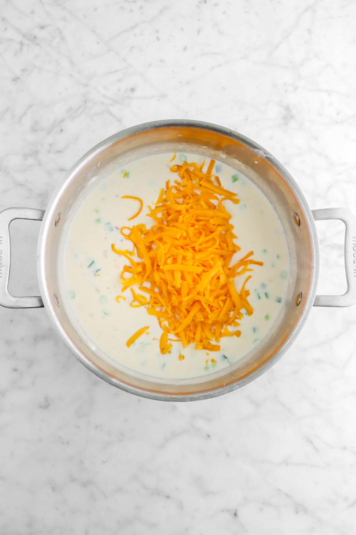 grated cheddar cheese added to soup
