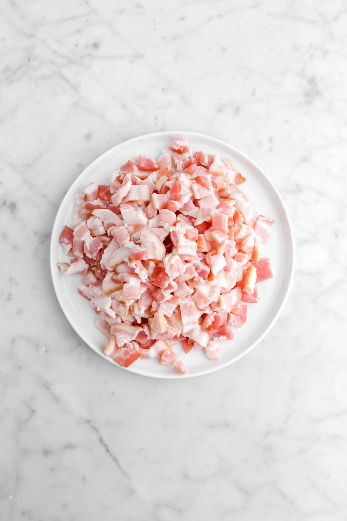 chopped raw bacon on white plate