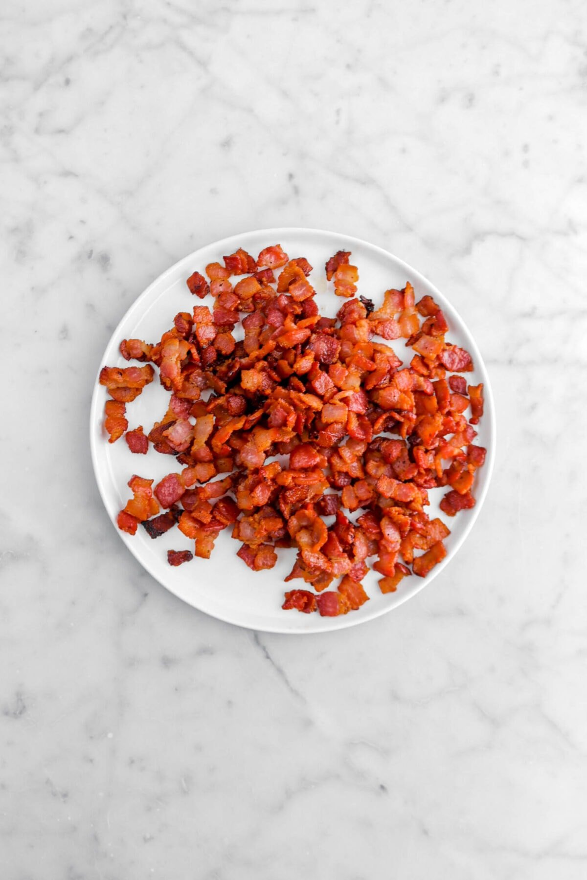 cooked chopped bacon on white plate