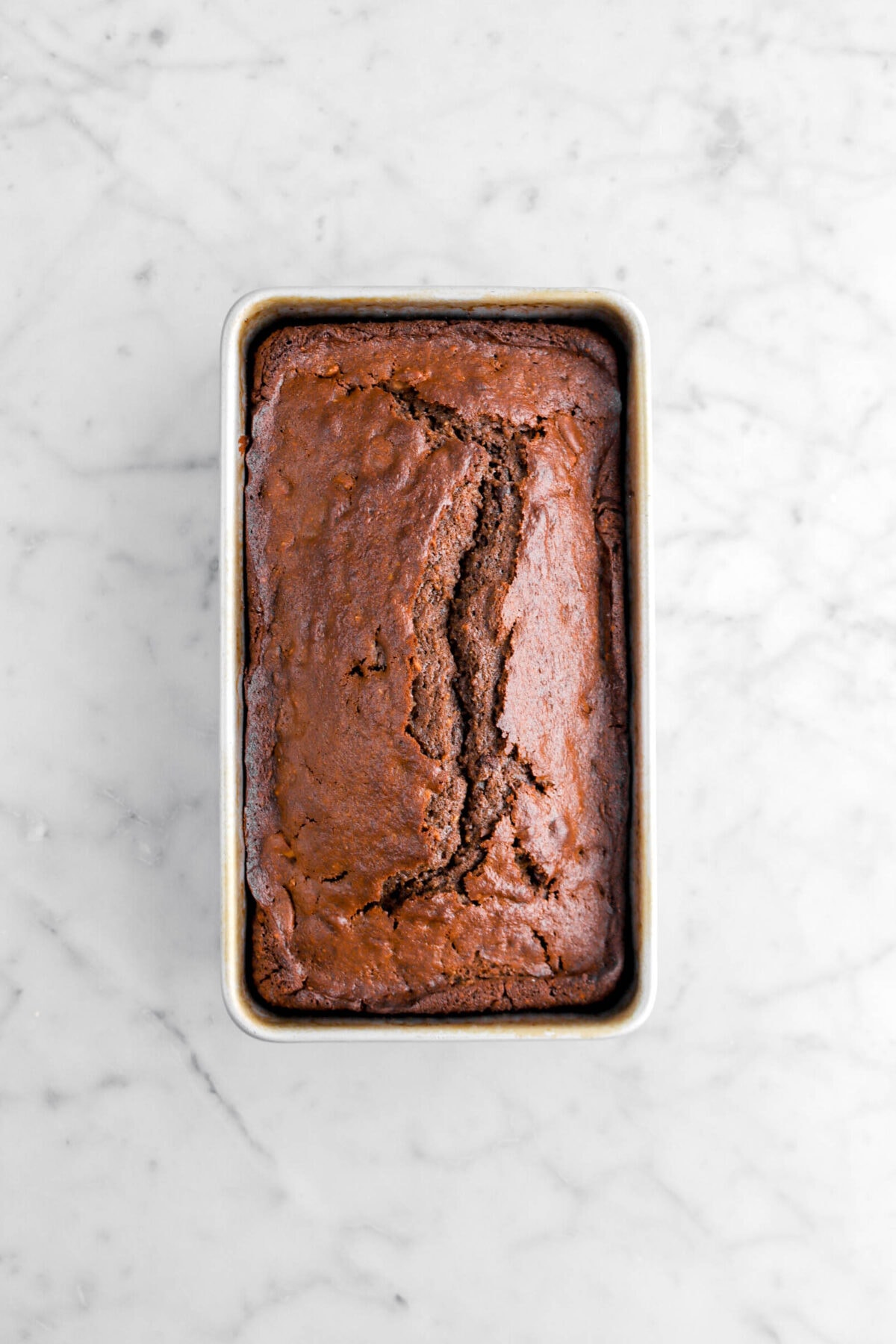 baked chocolate loaf in pan on marble surface