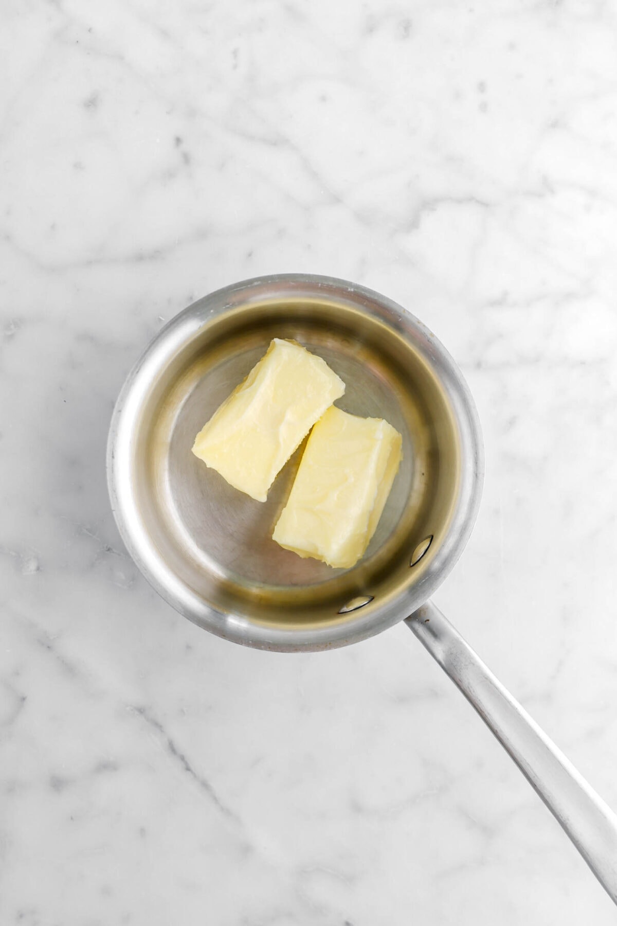 butter in small pot on marble surface