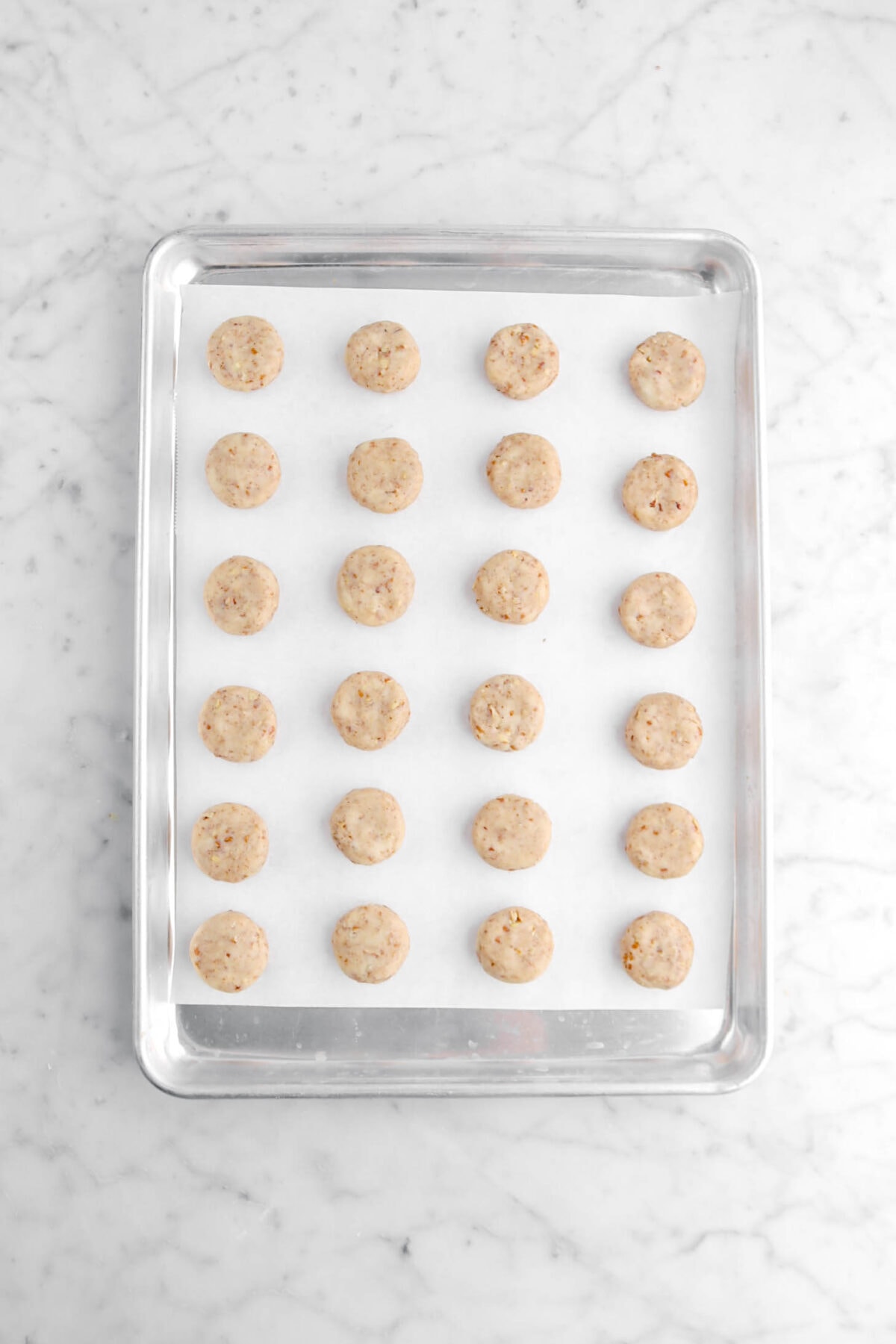 24 unbaked cookies on lined sheet pan