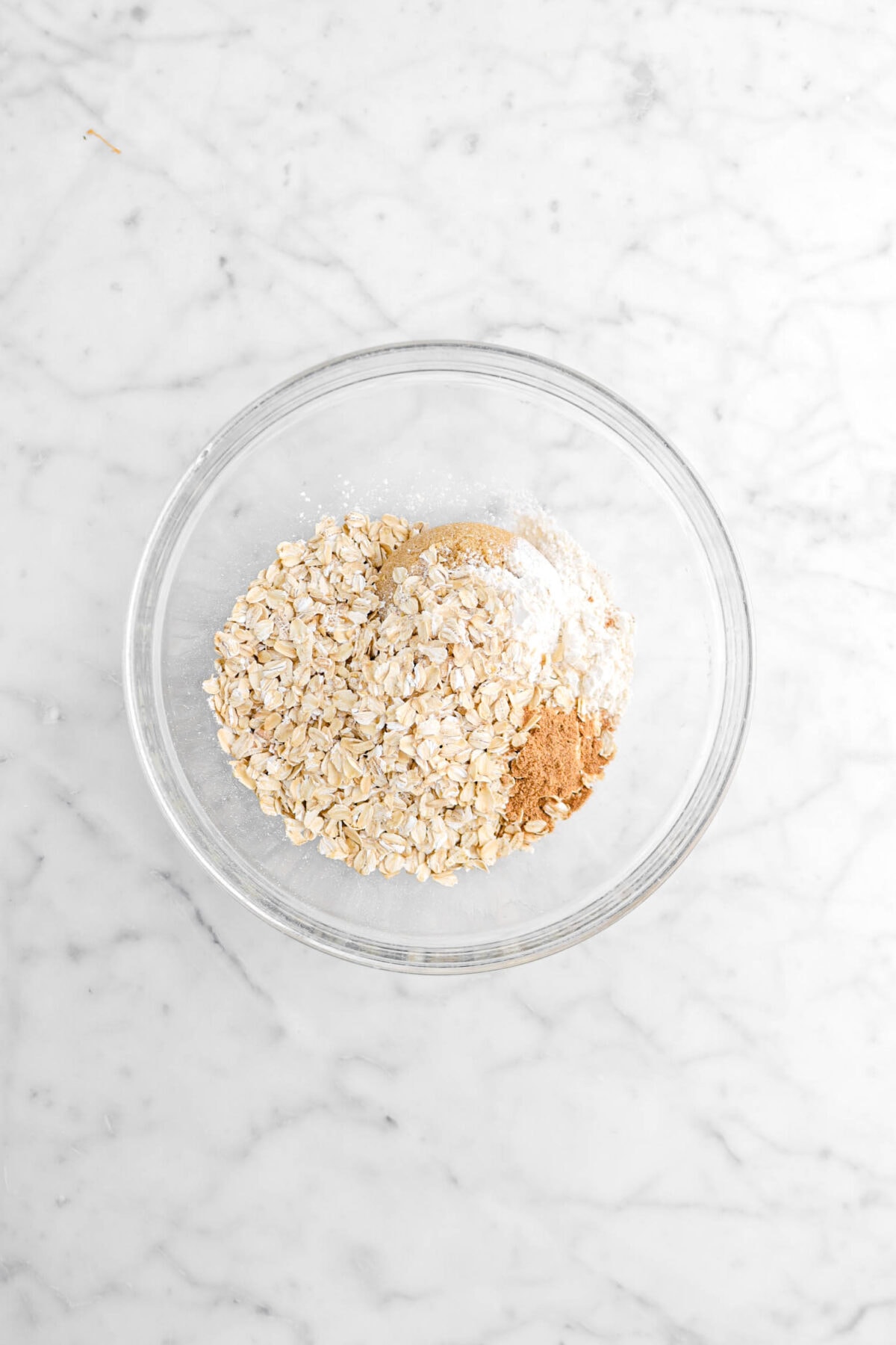 oats, brown sugar, nutmeg, and flour in glass bowl