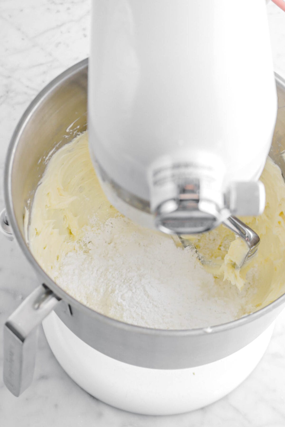 Powdered sugar and creamed butter in stand mixer bowl