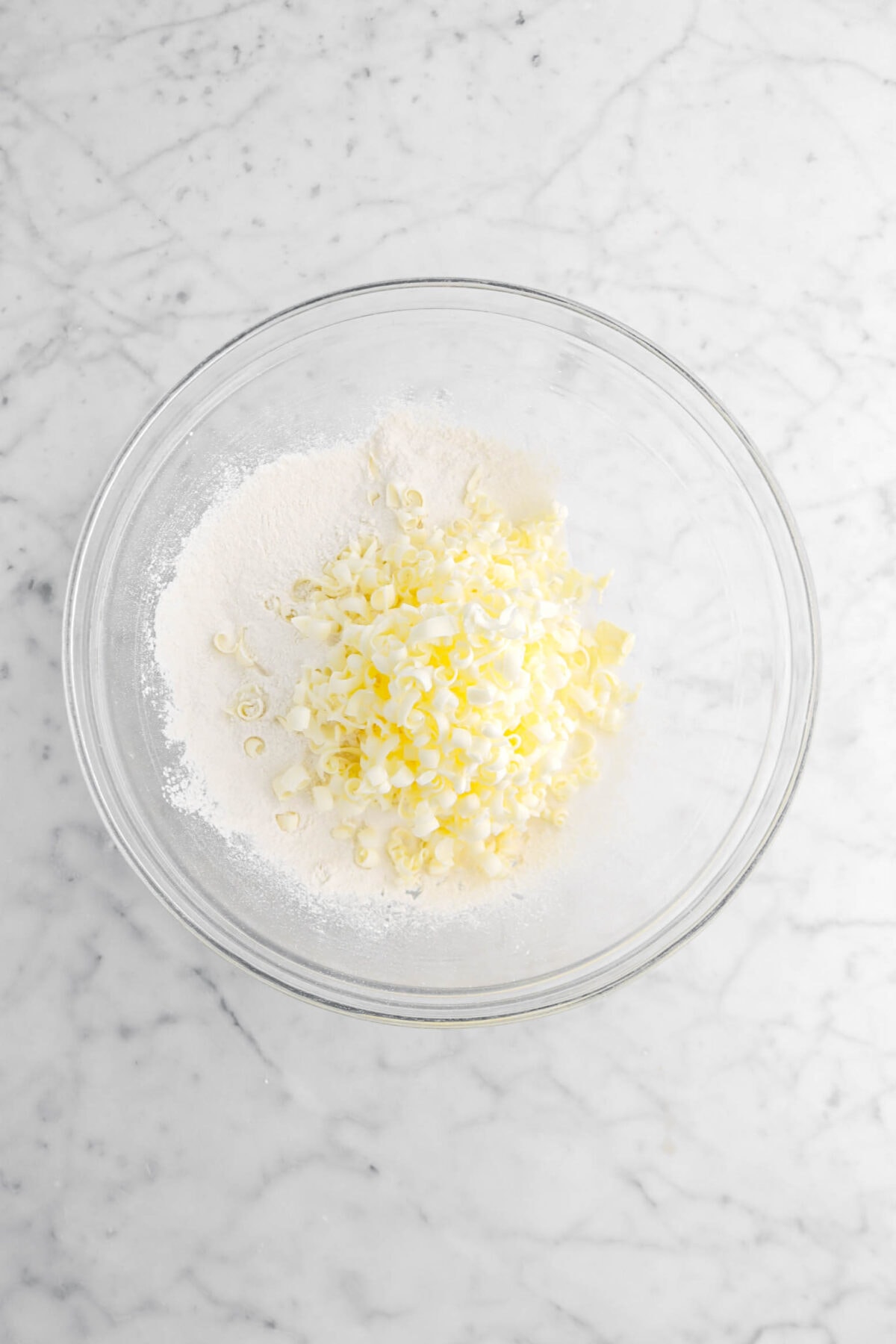 grated butter and dry ingredients in glass bowl