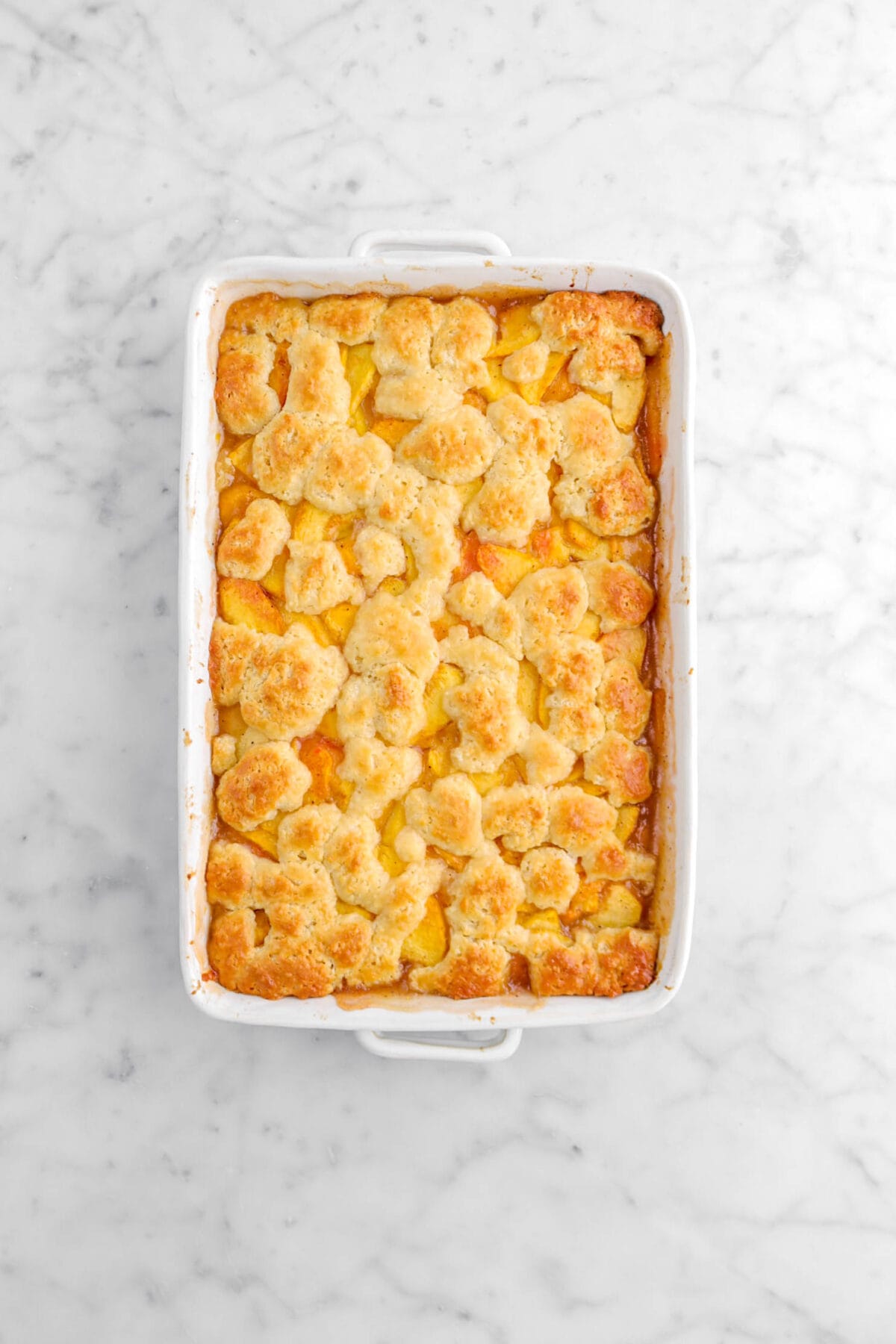 baked peach cobbler on marble surface