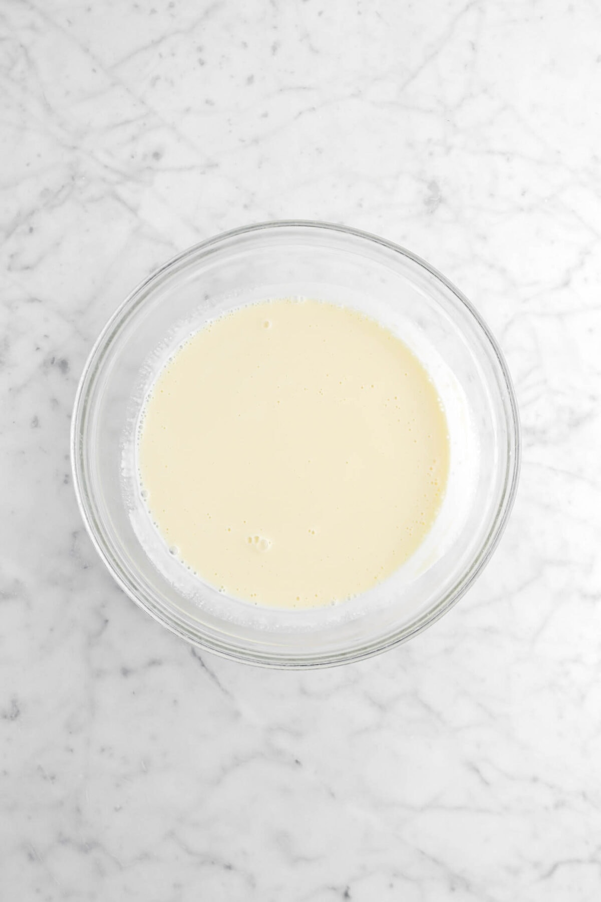 vanilla custard in glass bowl on marble surface