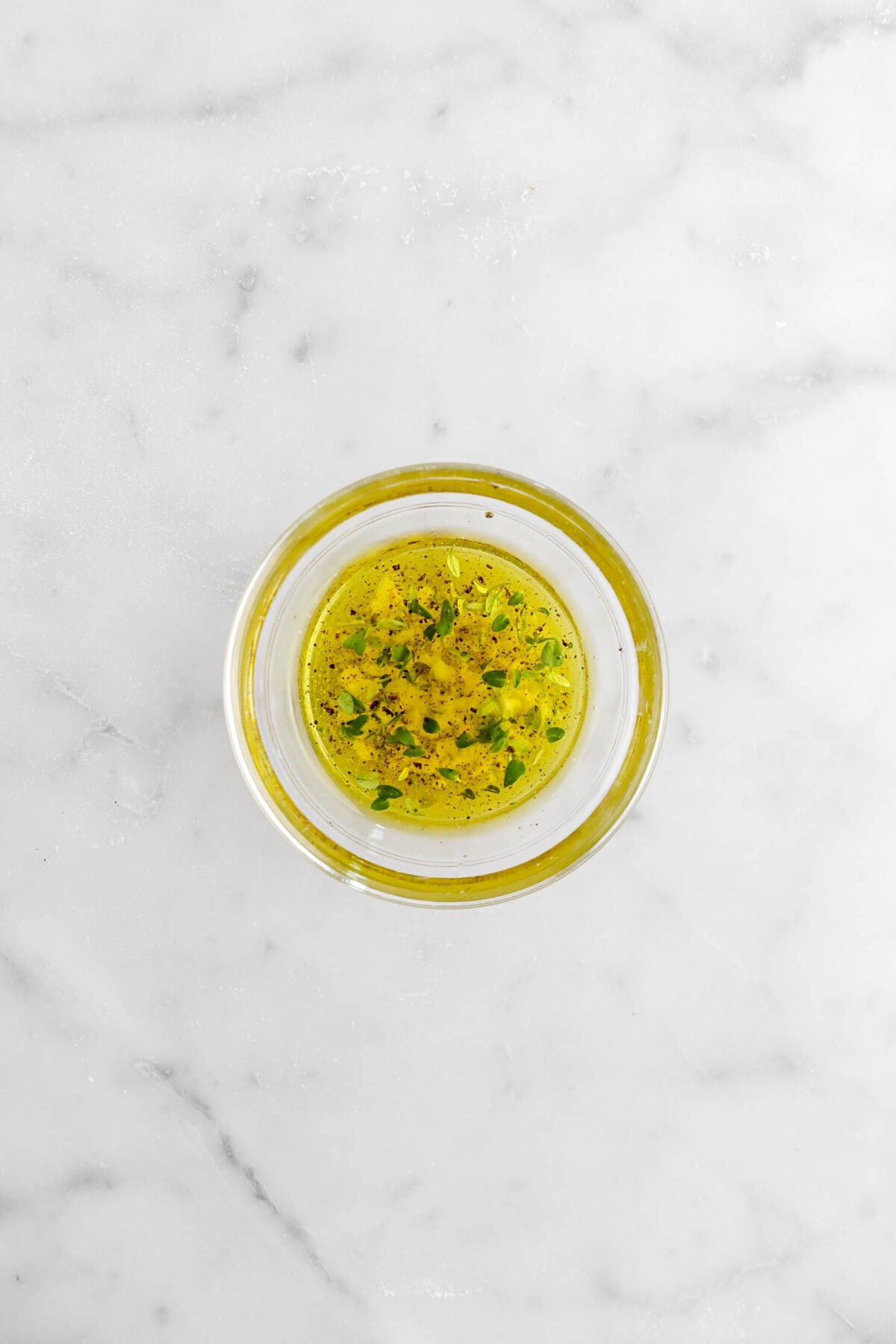 olive oil mixture in glass bowl on marble surface