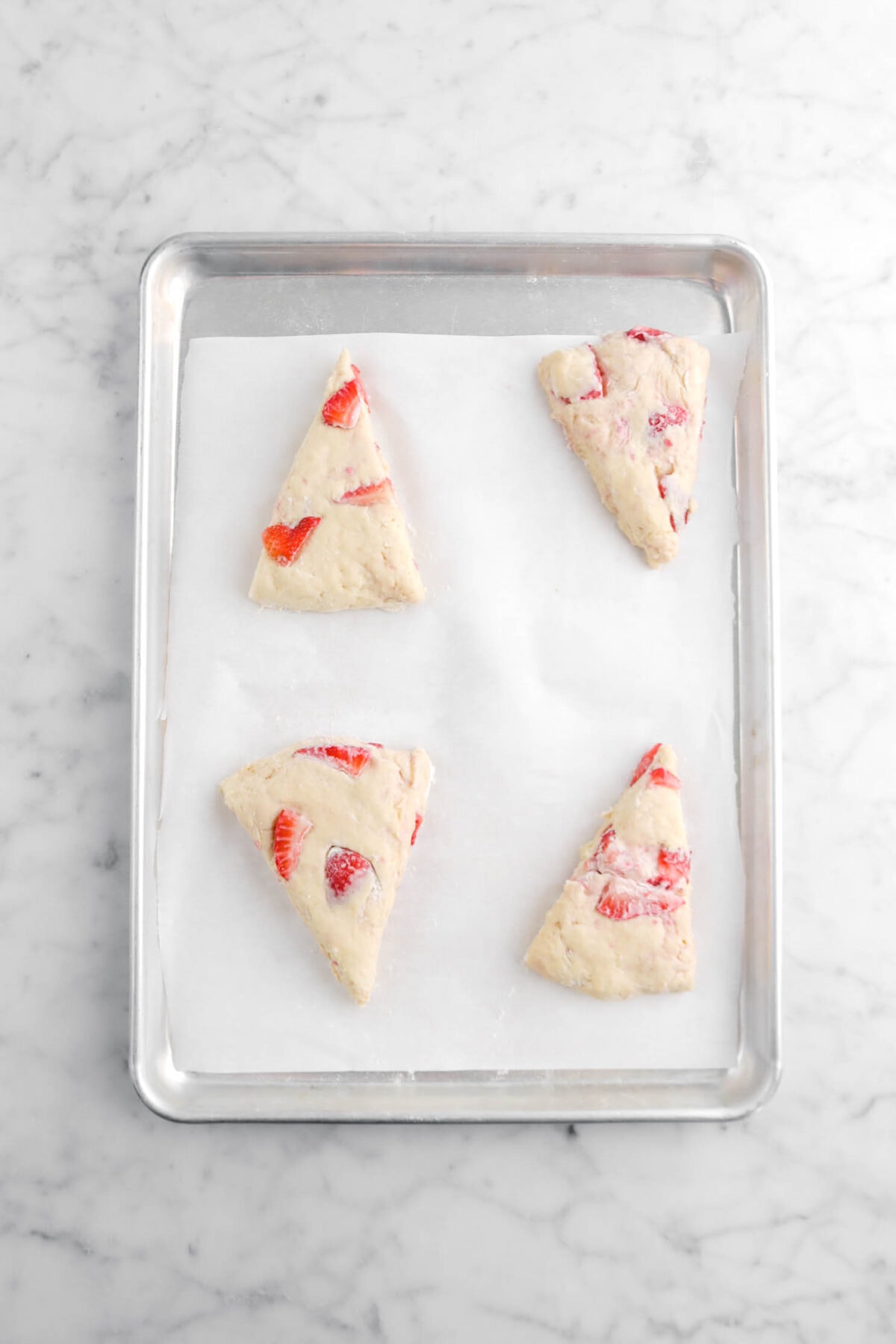 four scones on lined sheet pan