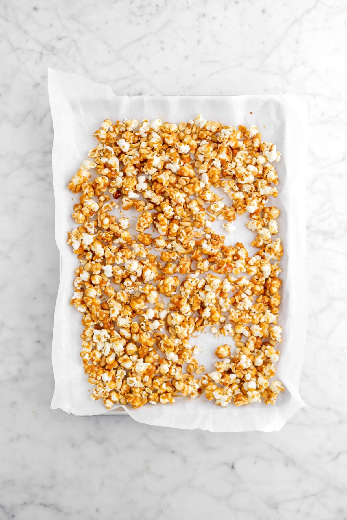 toffee popcorn in lined sheet pan