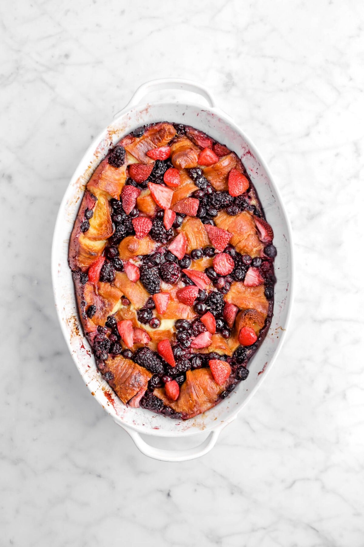 baked berry casserole in white casserole dish