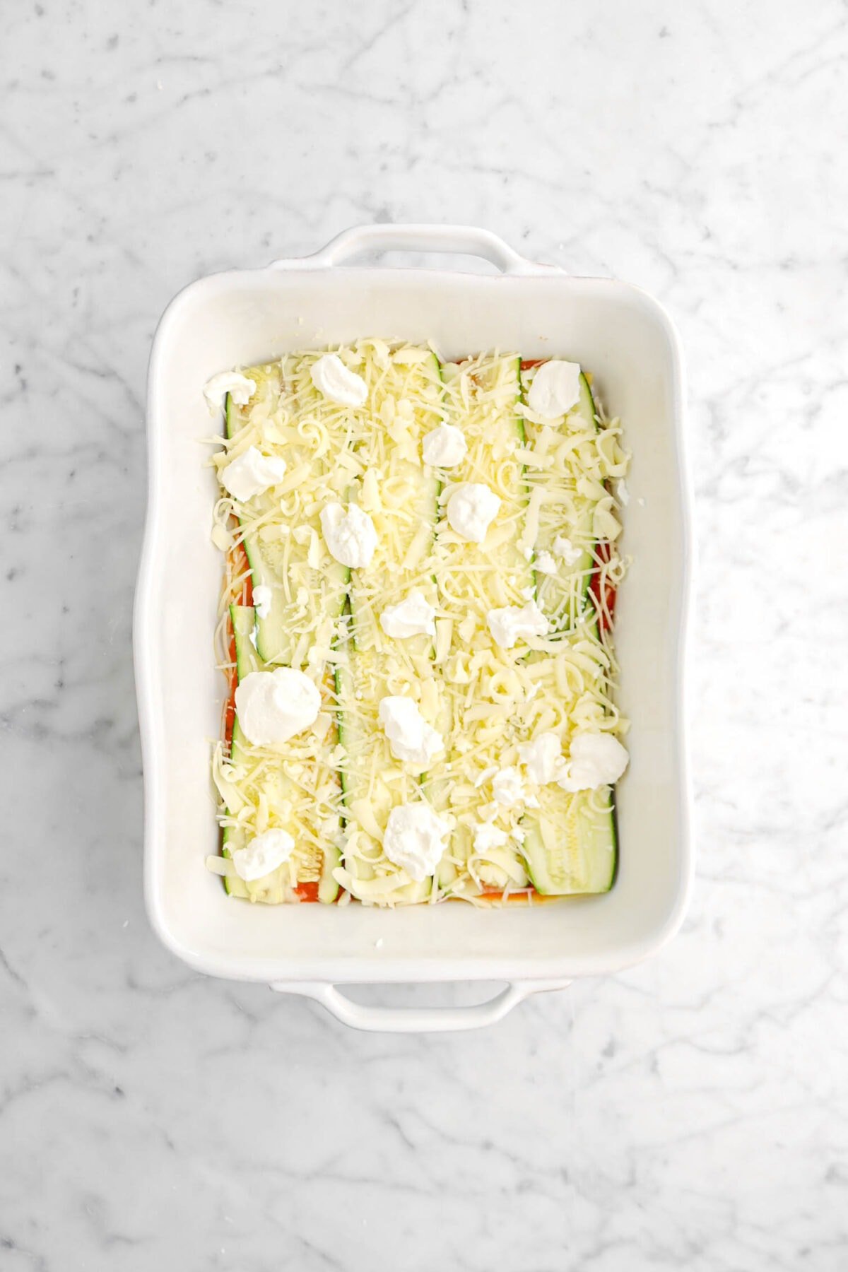 cheese spread on top of zucchini layer
