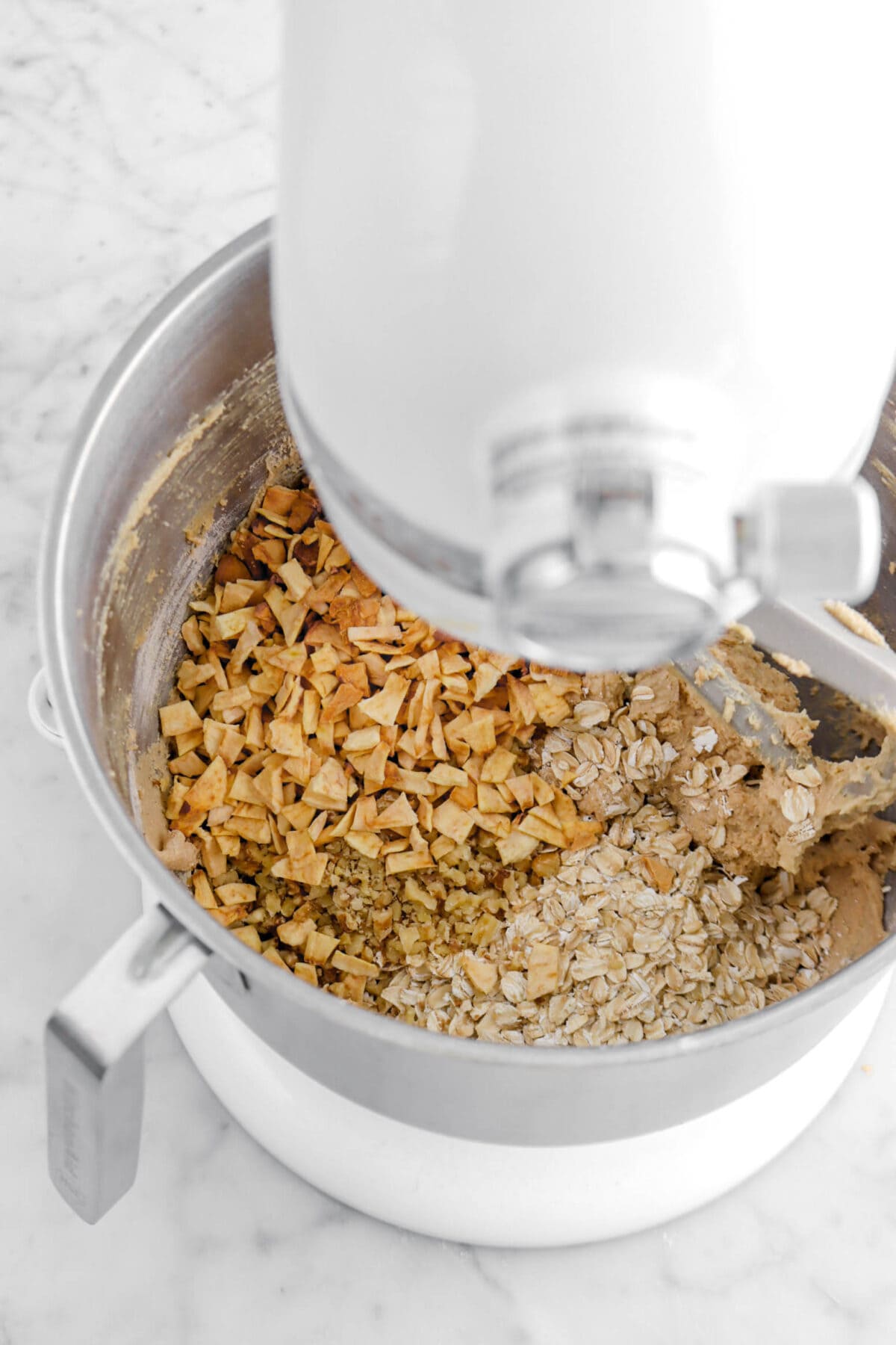 dried apples, walnuts, and oatmeal in mixer bowl.