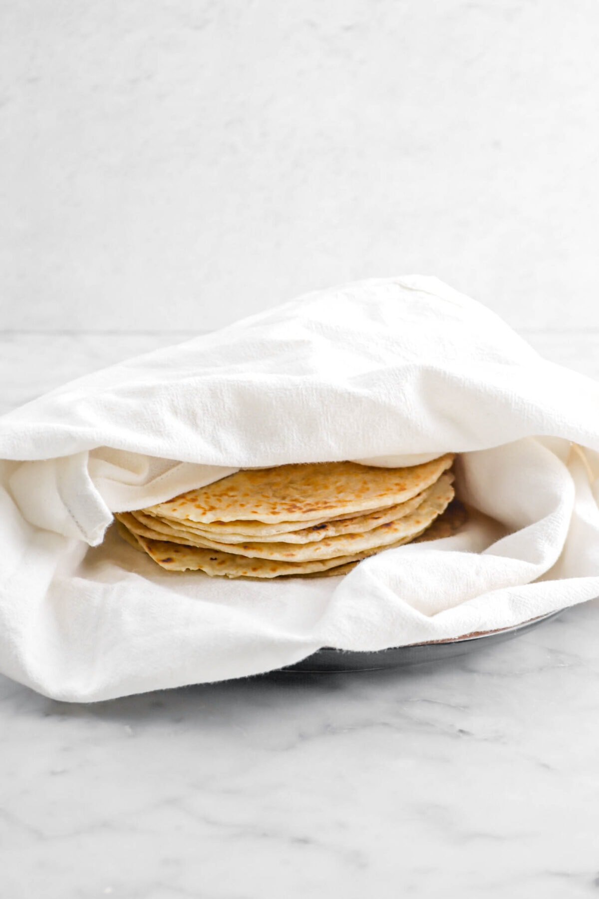 tortillas wrapped in white napkin