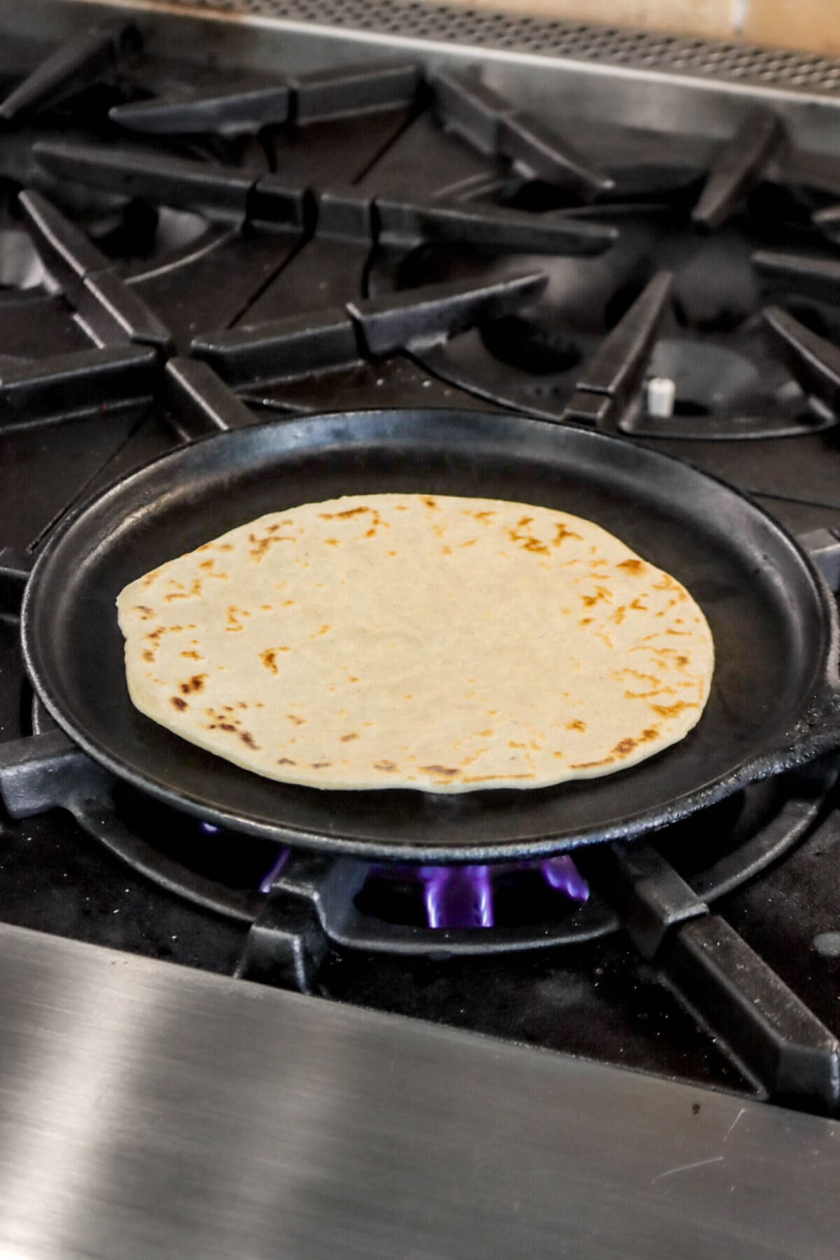 cooked tortilla on cast iron skillet