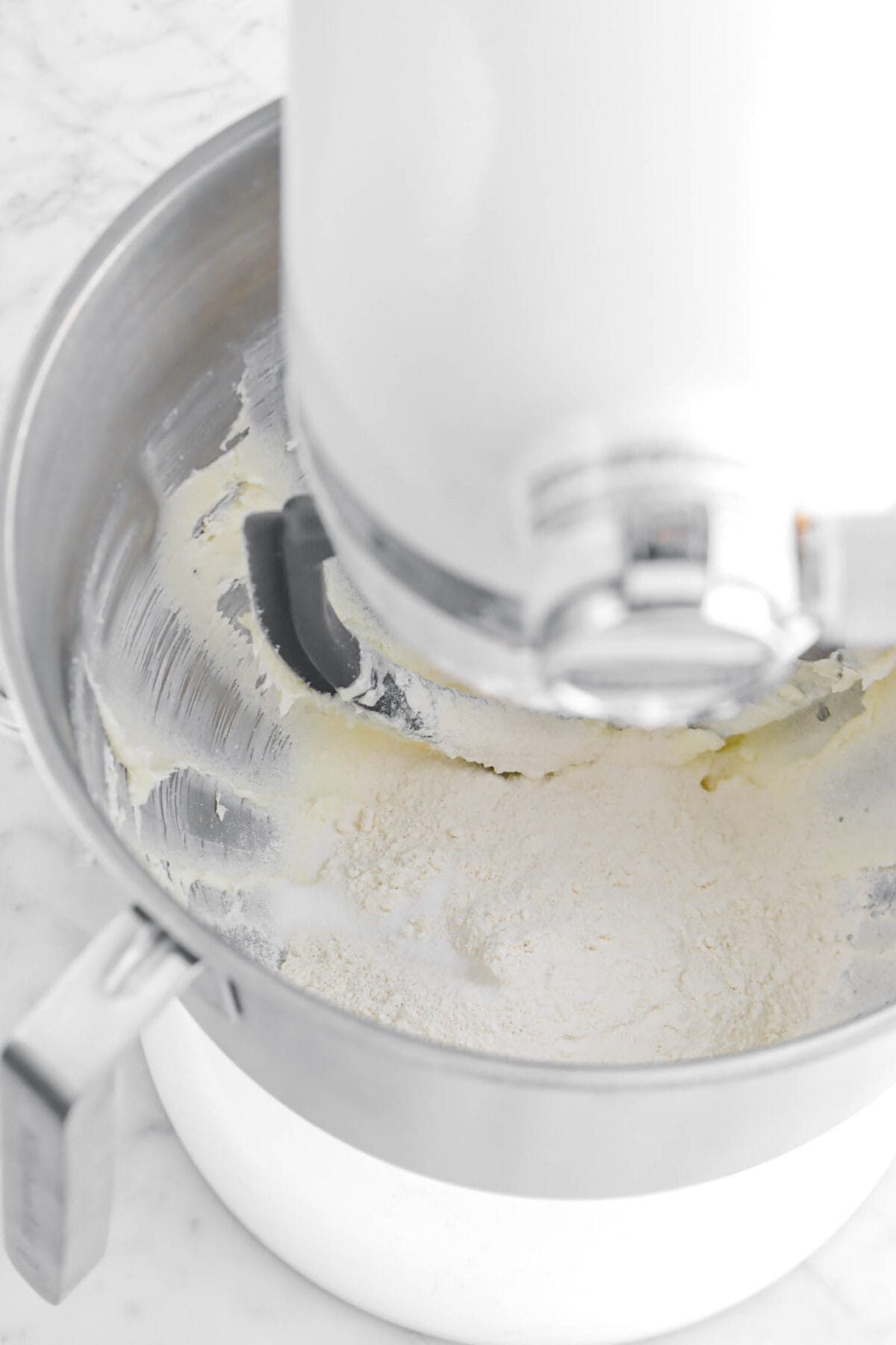 flour and salt in mixer with creamed butter and sugar