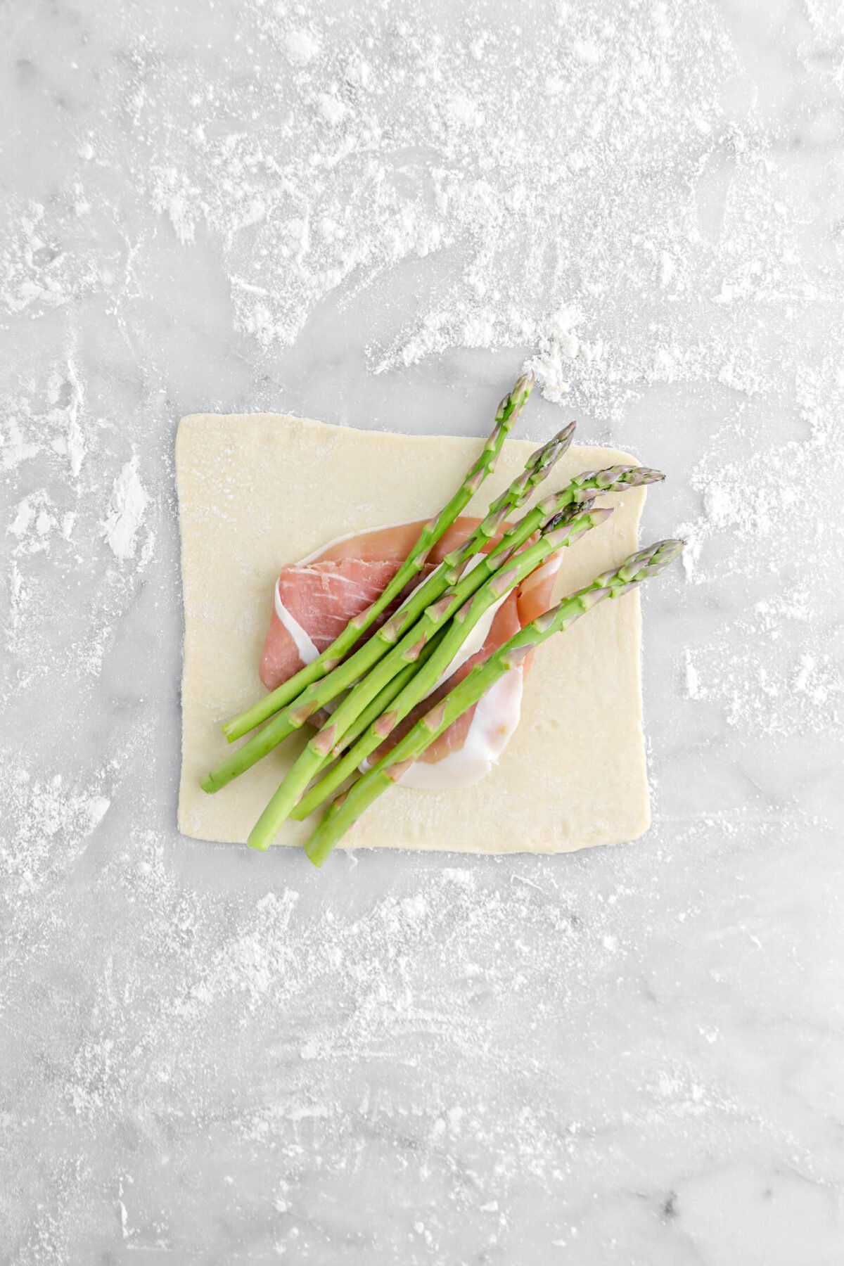 six asparagus added on top of brie .