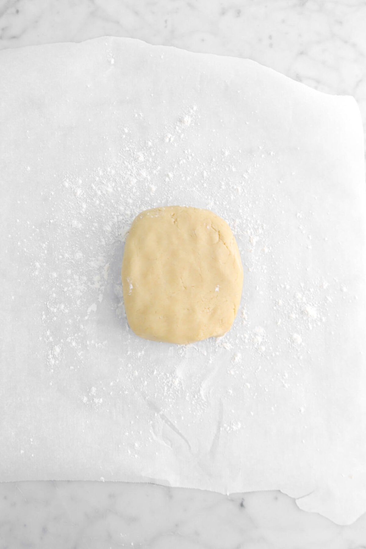 cookie dough on floured parchment paper.