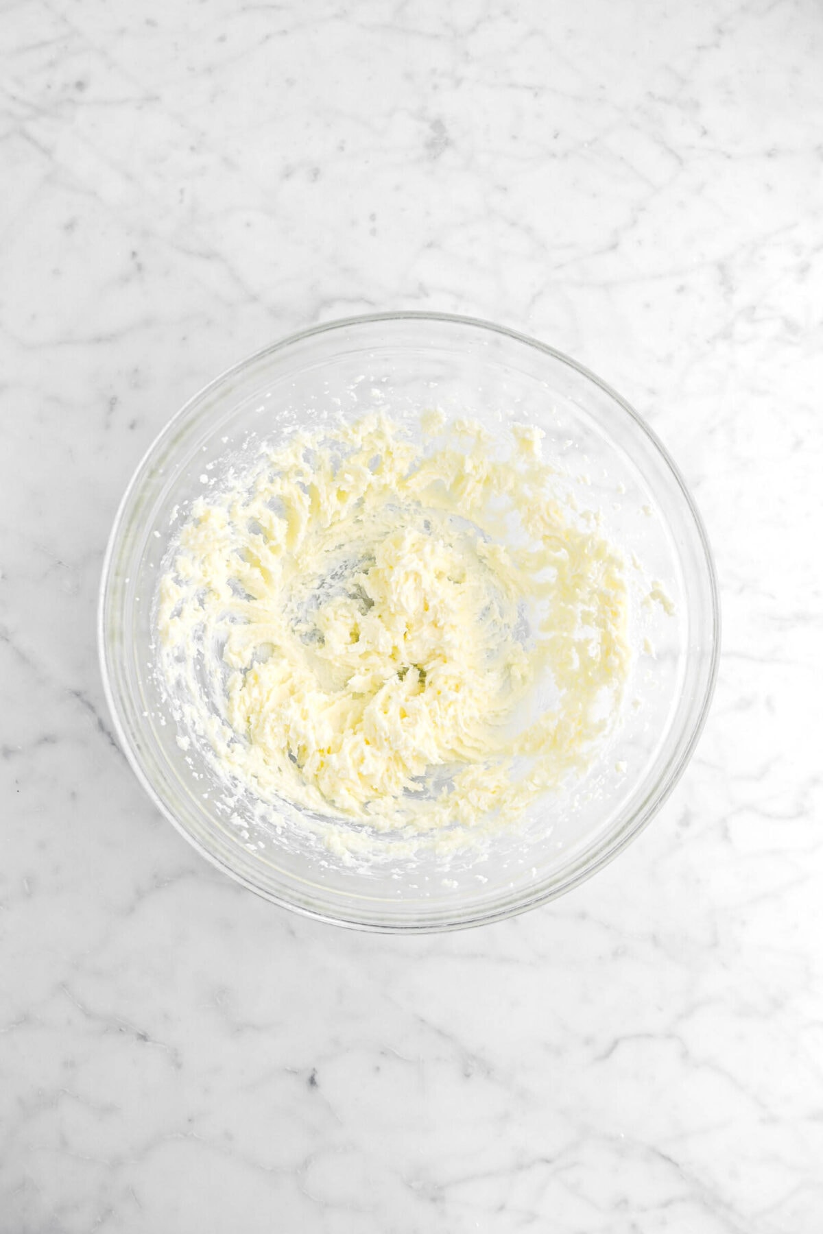 butter and sugar mixed together in glass bowl.