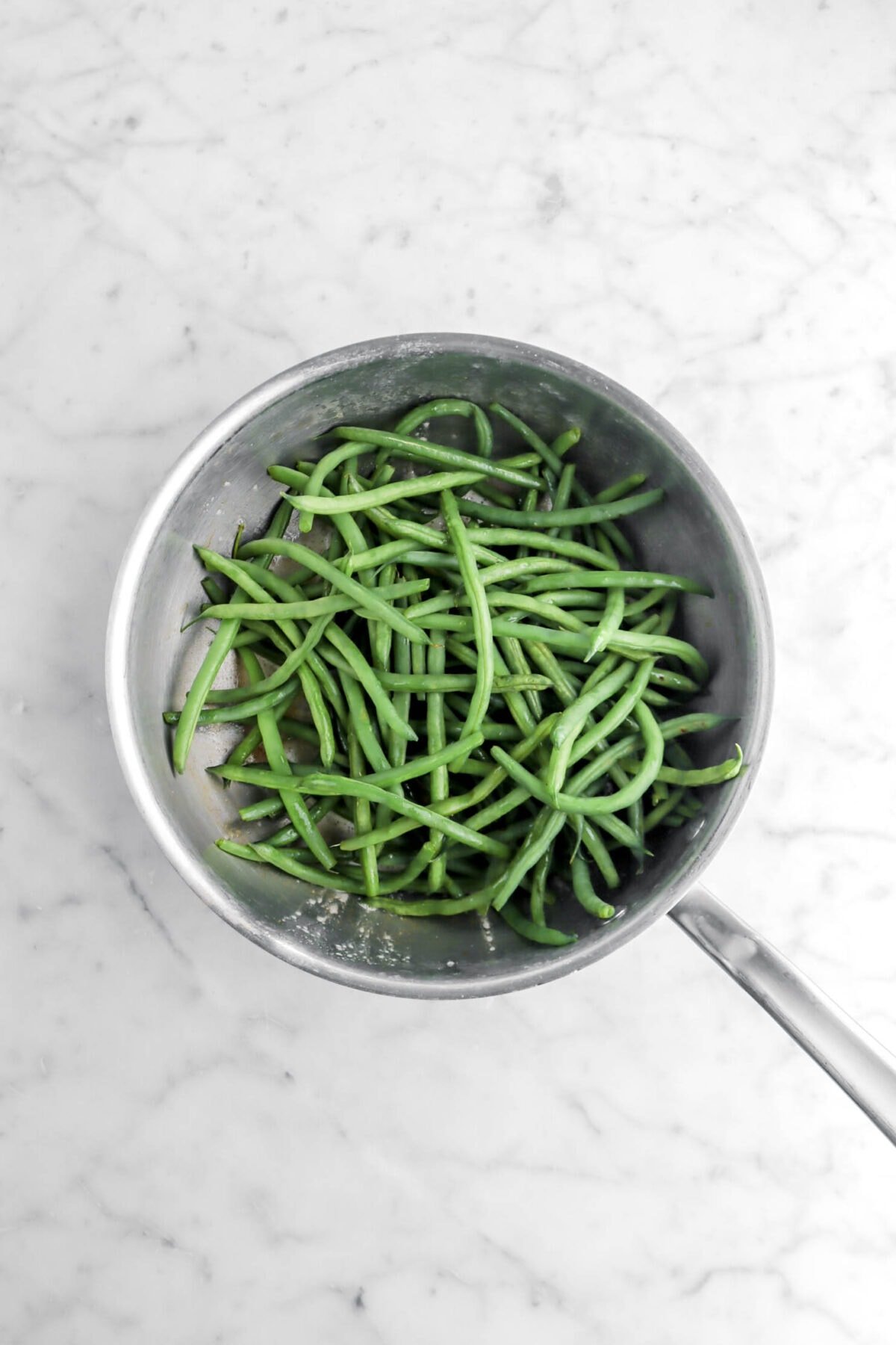 blanched green beans added to sauté pan.