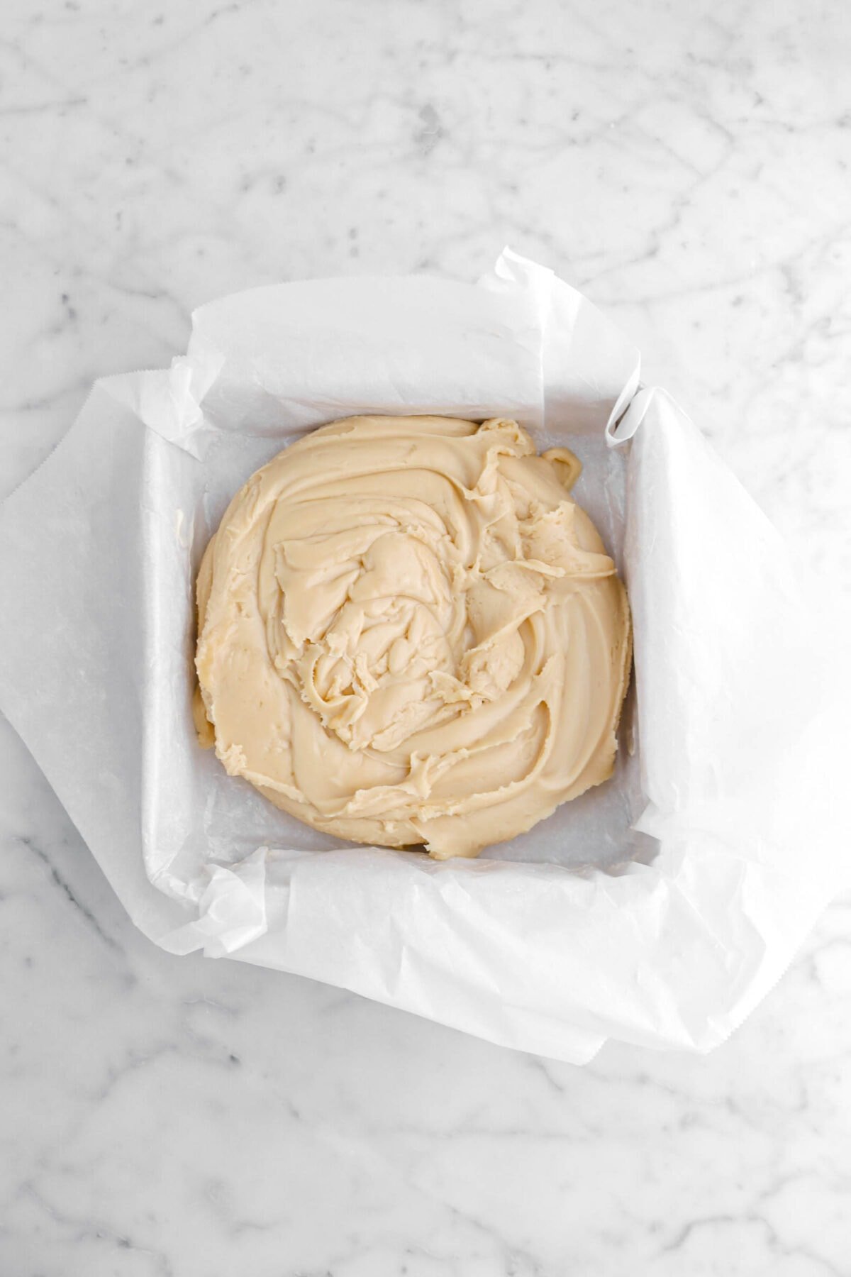 fudge piled in parchment lined cake pan.