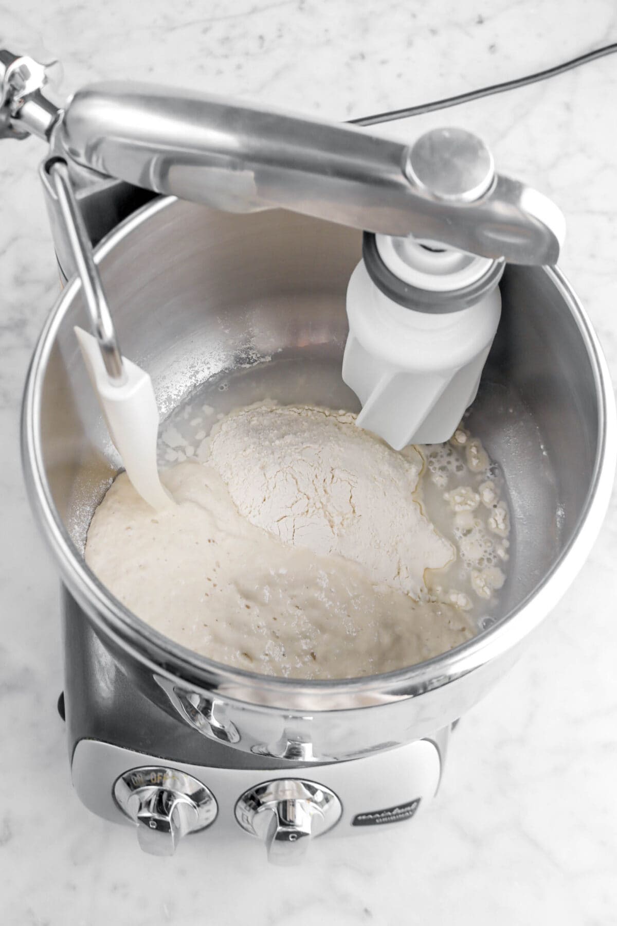 sourdough starter, flour, and water in mixer.