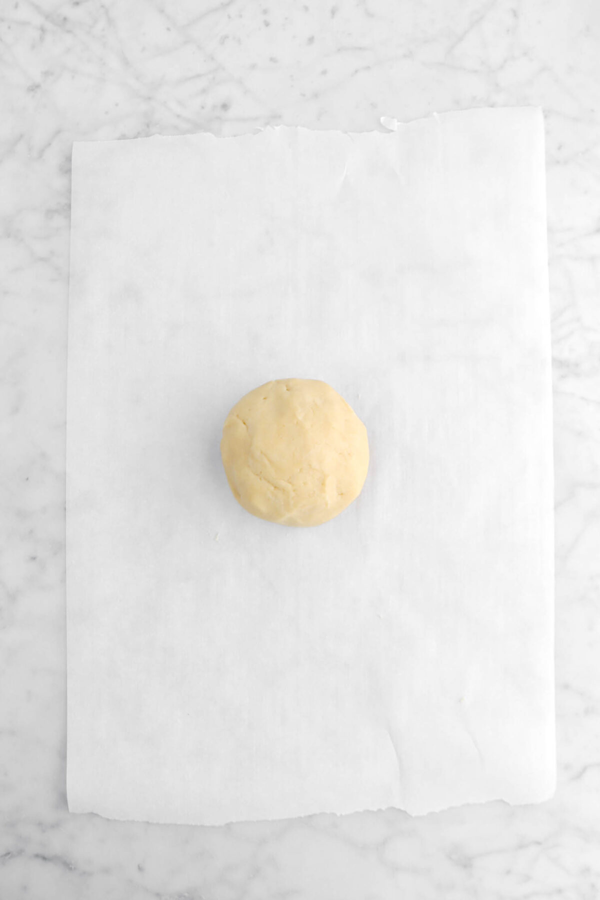 dough ball on parchment paper.