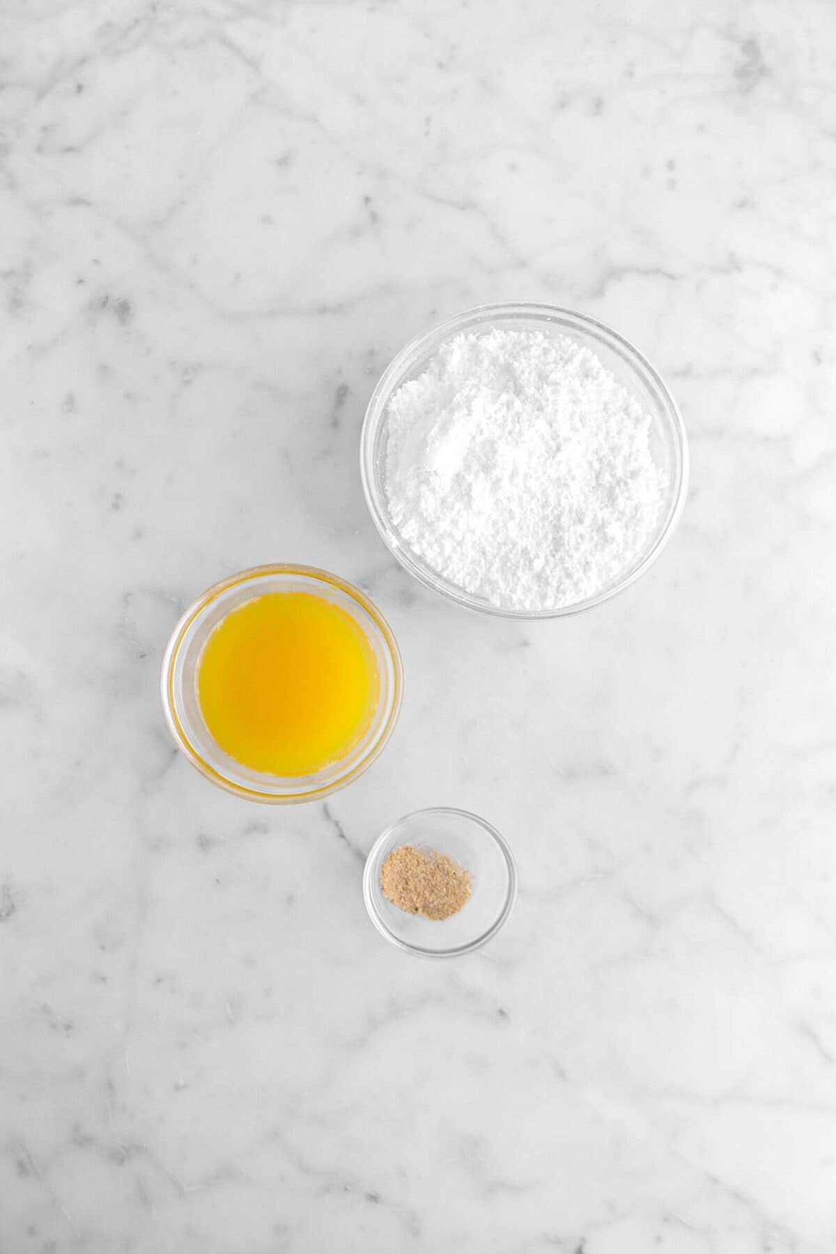 powdered sugar, orange juice, and ground cardamom in glass bowls.