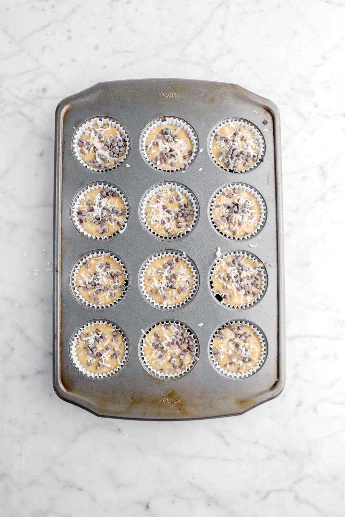 mini chocolate chips and shredded coconut added on top of muffin batter.