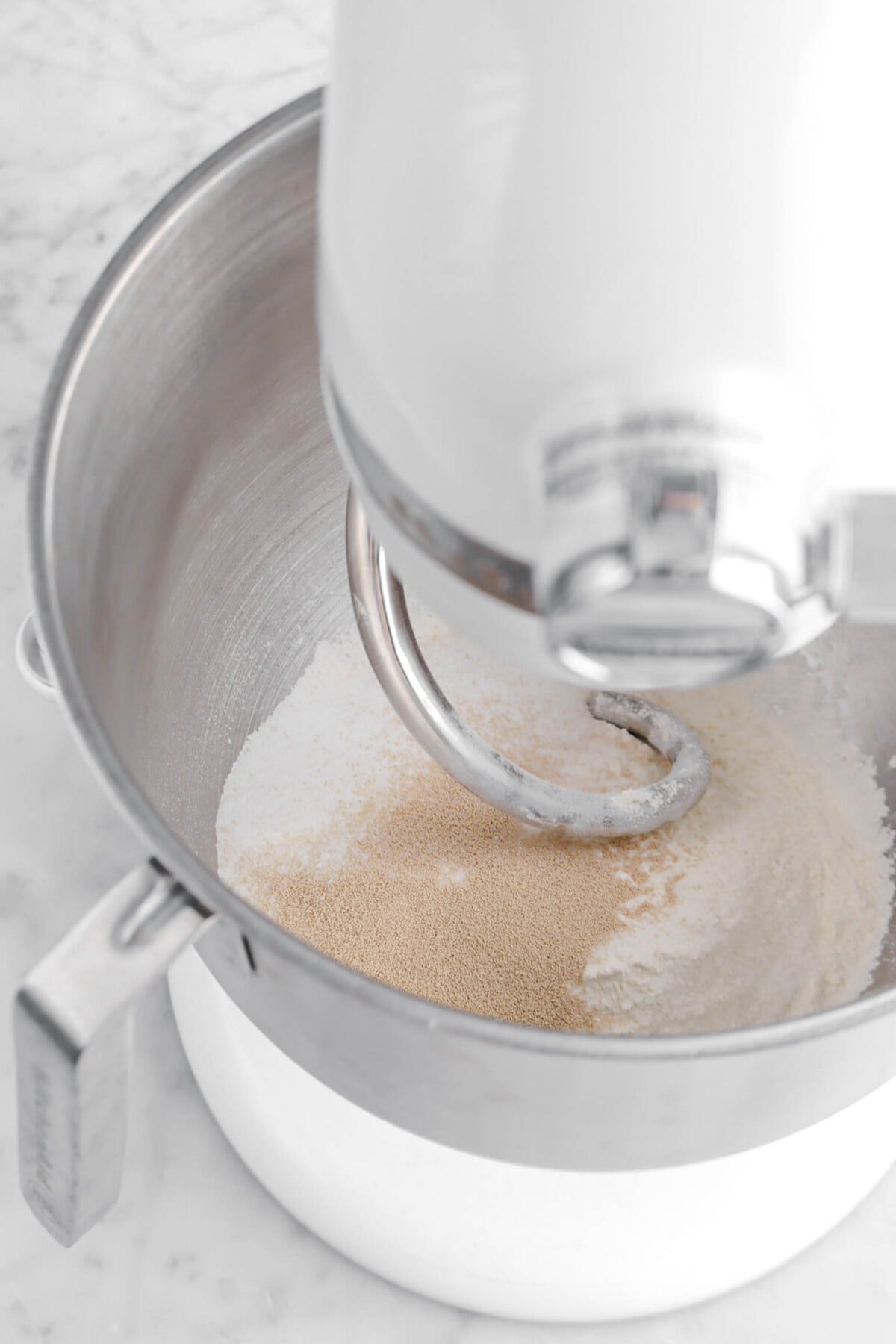 yeast, sugar, salt, and flour in mixer with dough hook.