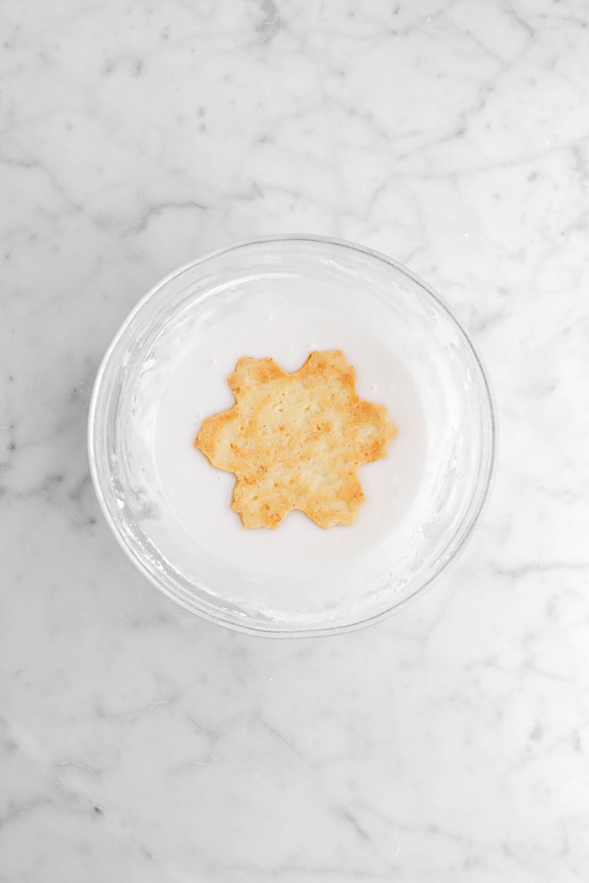 upside down snowflake cookie in icing.