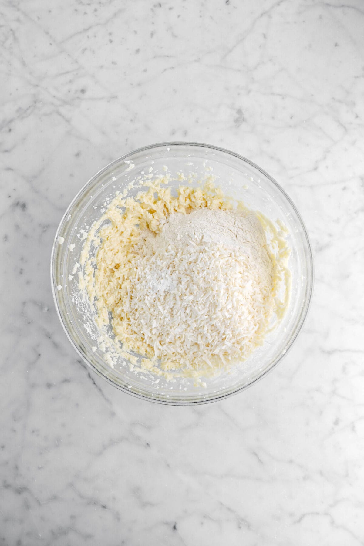 flour, shredded coconut, and baking powder added to butter mixture.