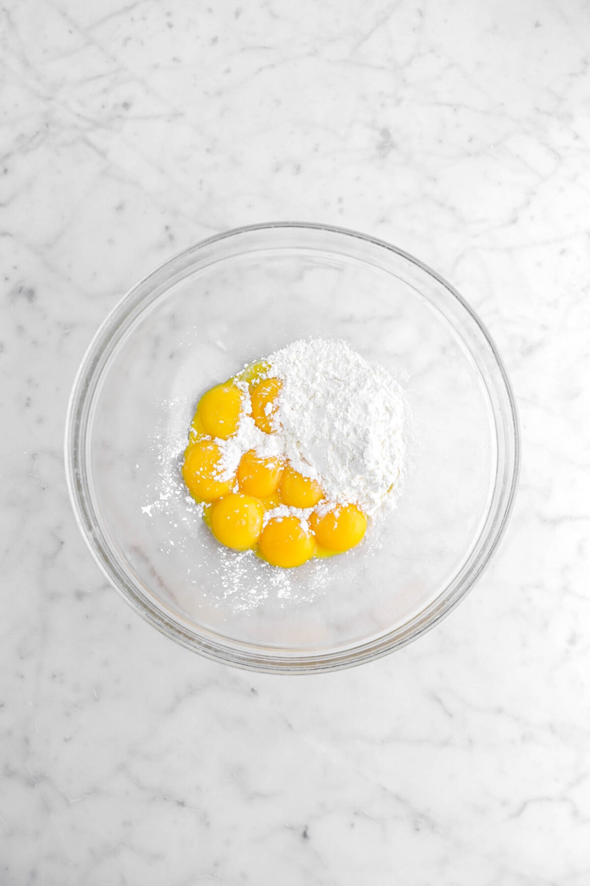 egg yolks and corn starch in glass bowl.