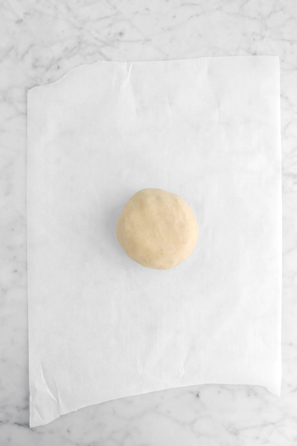 dough ball on parchment paper.