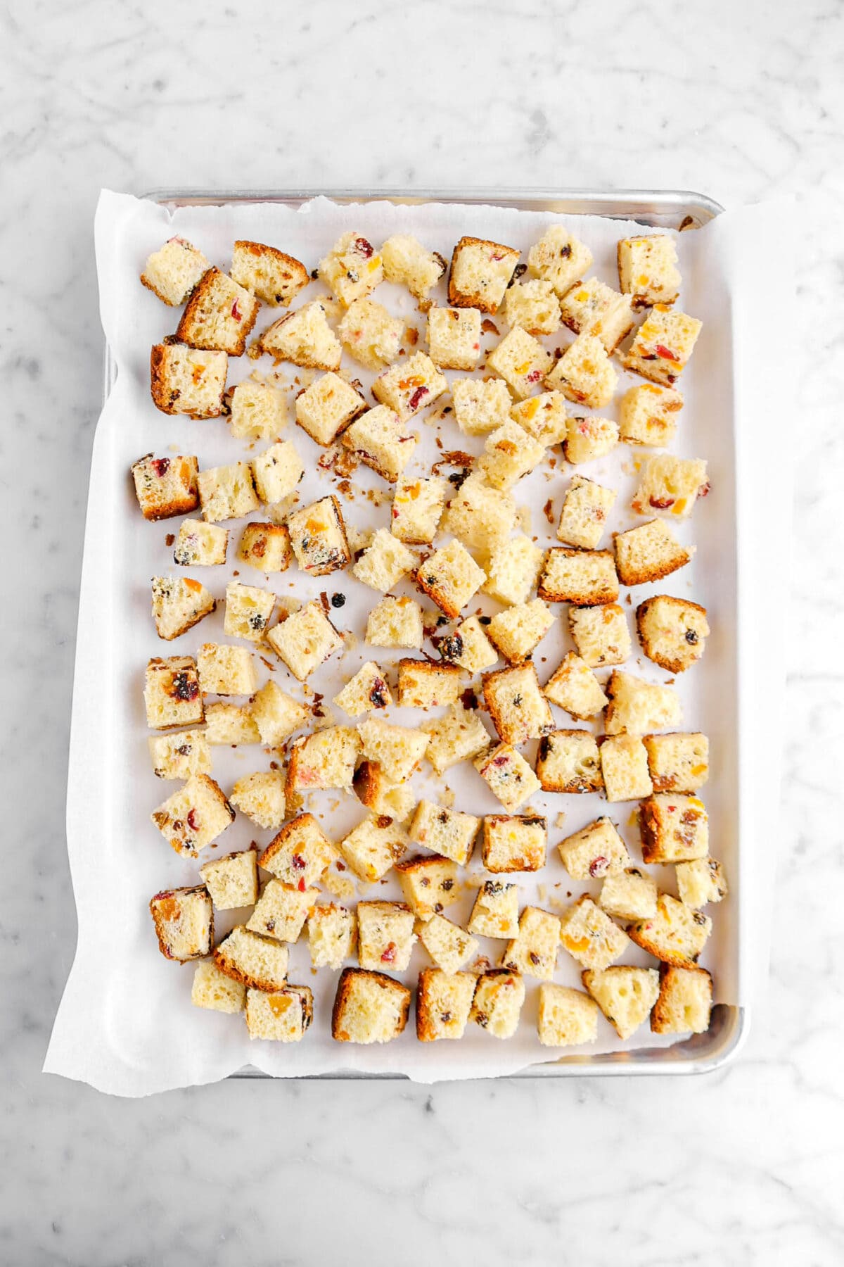 cubed panettone on lined sheet pan.
