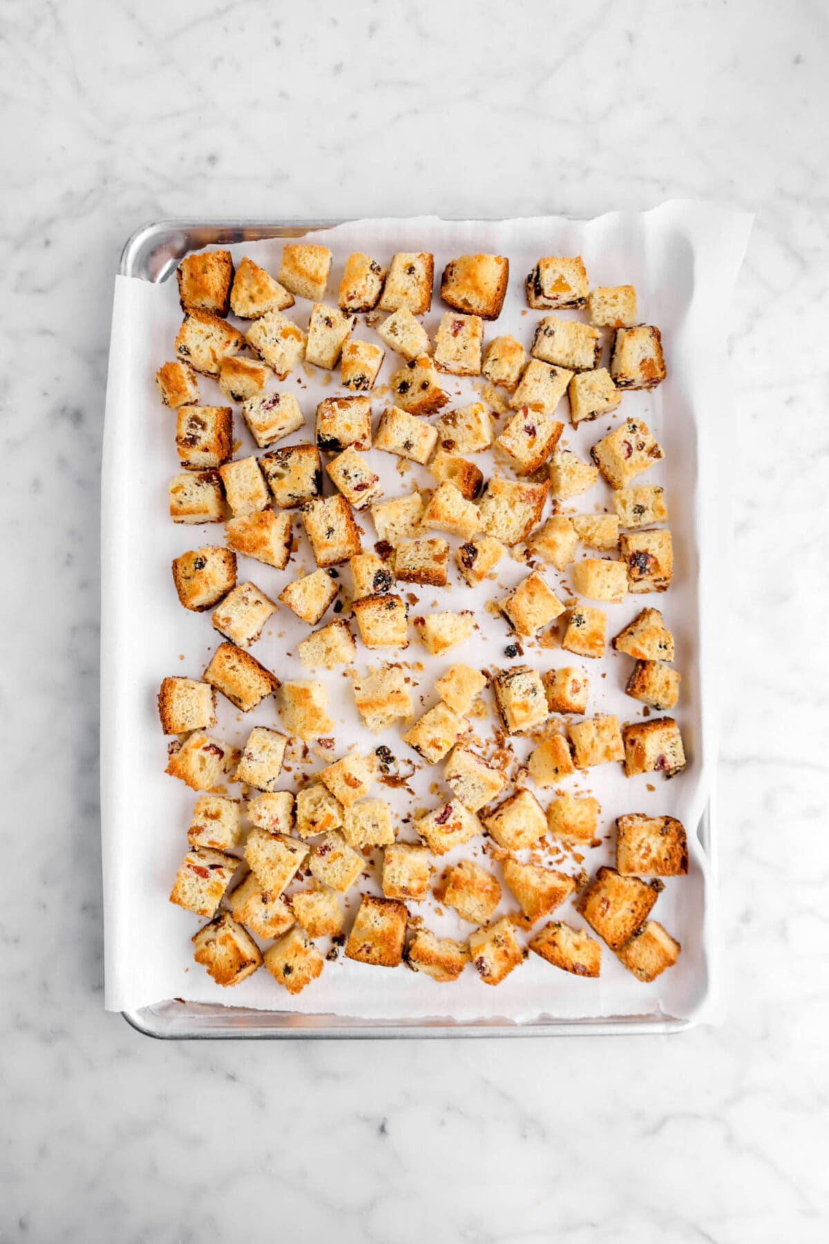 toasted cubed panettone on lined sheet pan.