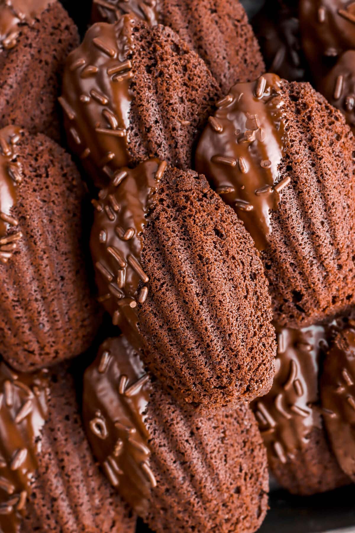 close up of piled chocolate madeleines.