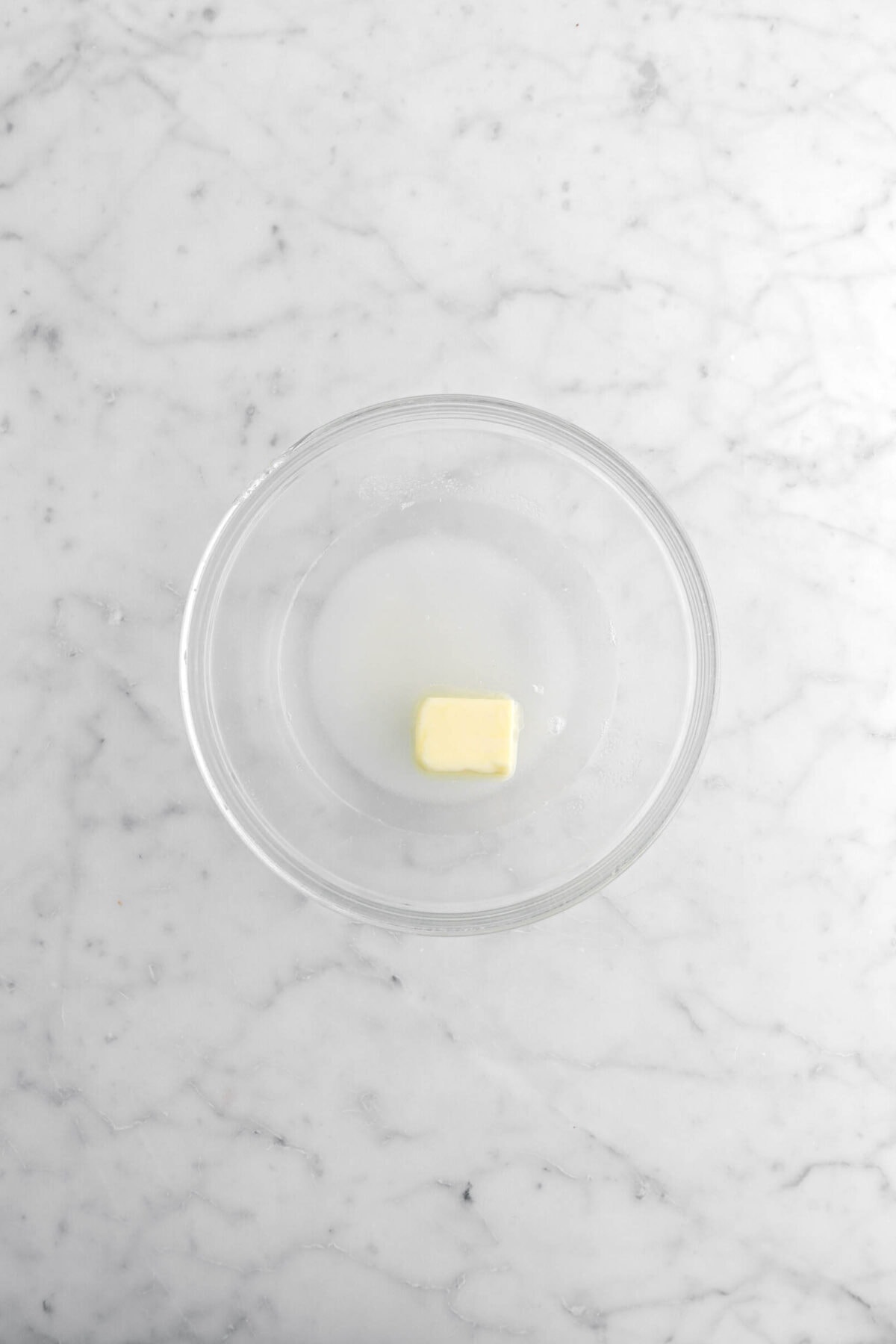 sugar, butter, and water in glass bowl.