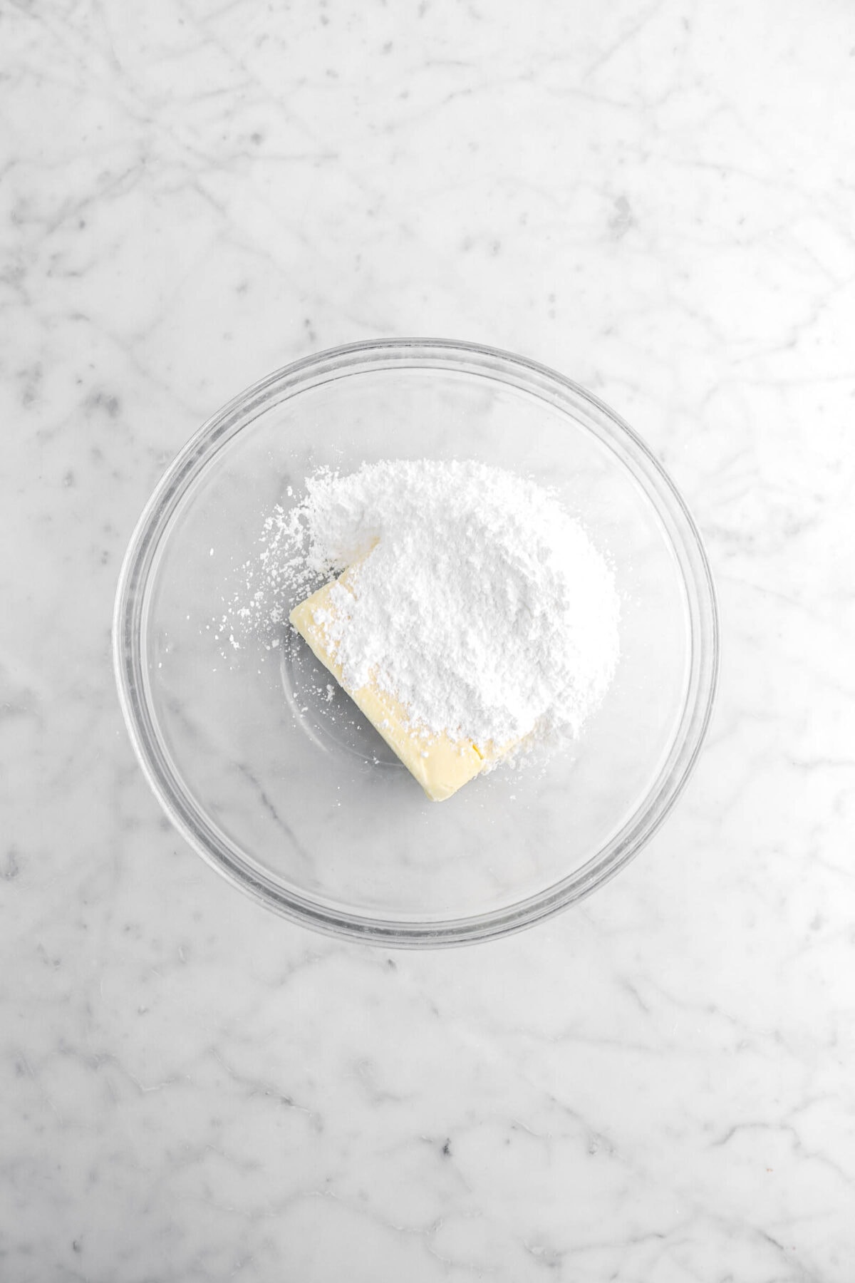 butter and powdered sugar in glass bowl.