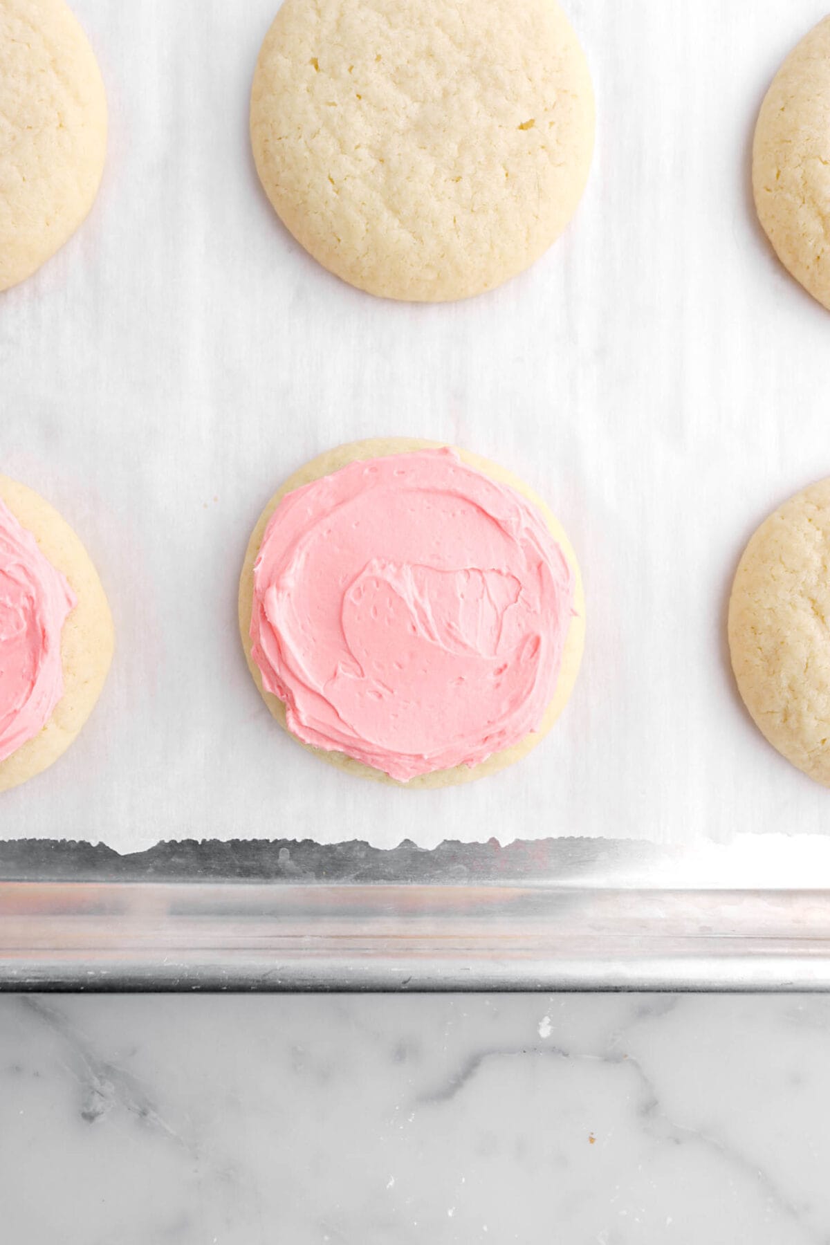 pink frosting spread across cookie.