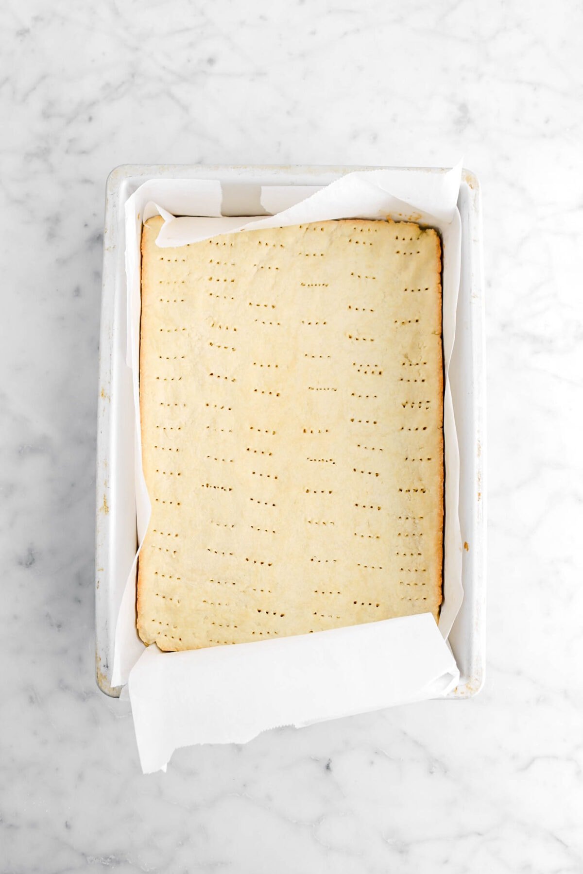 baked shortbread in lined cake pan.