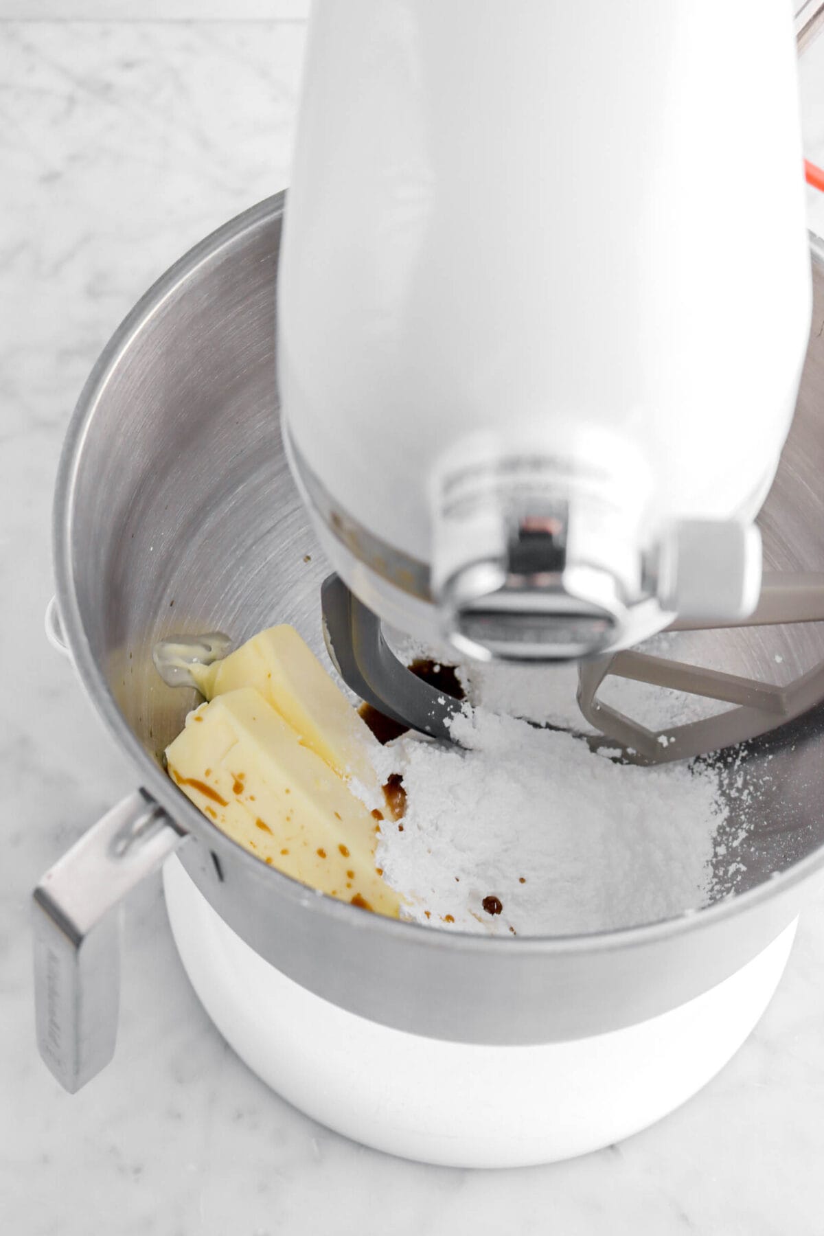 butter, powdered sugar, and vanilla in stand mixer.