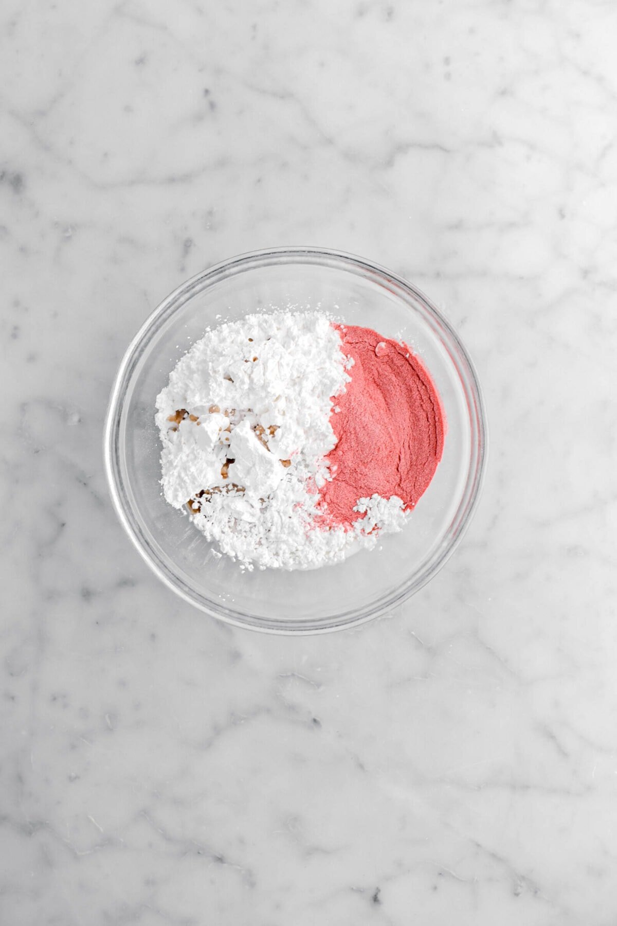 strawberry powder, milk, vanilla, and powdered sugar in glass bowl.