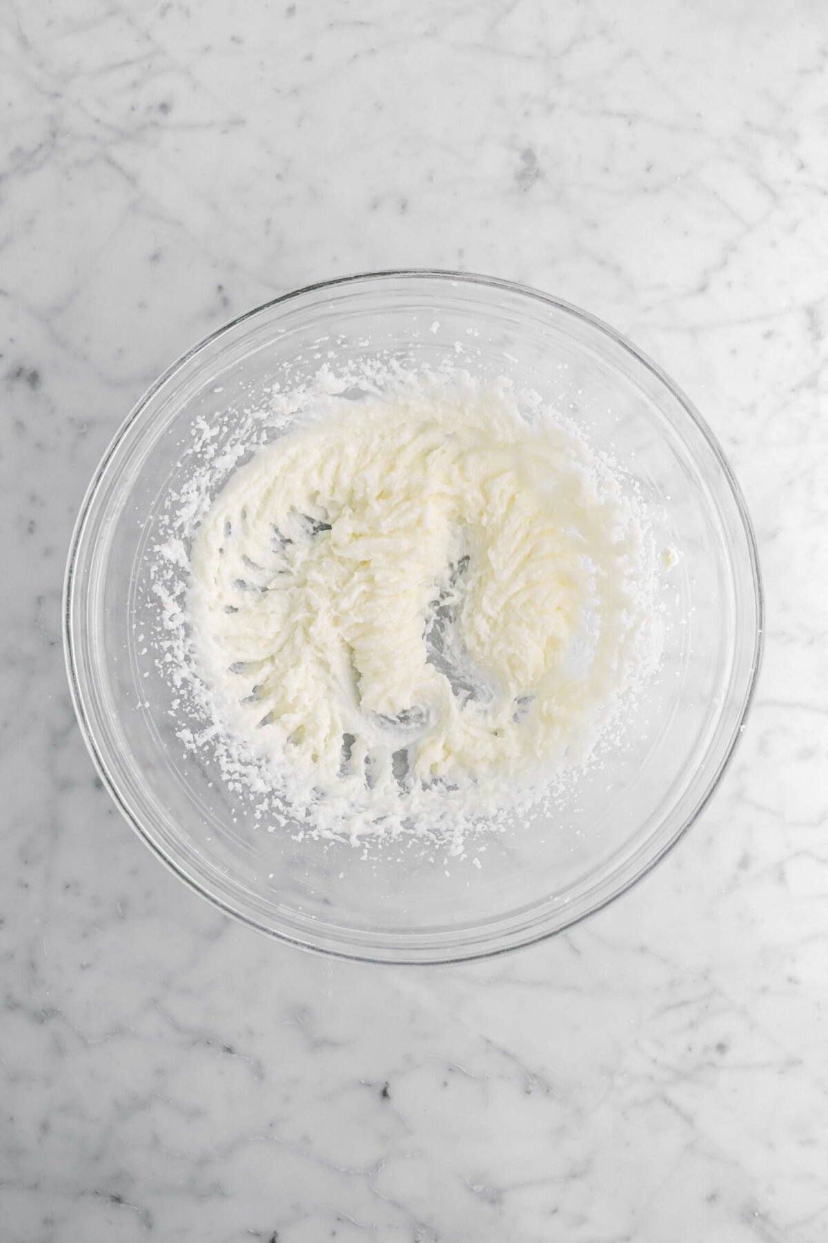 creamed butter, sugar, and coconut oil in glass bowl.