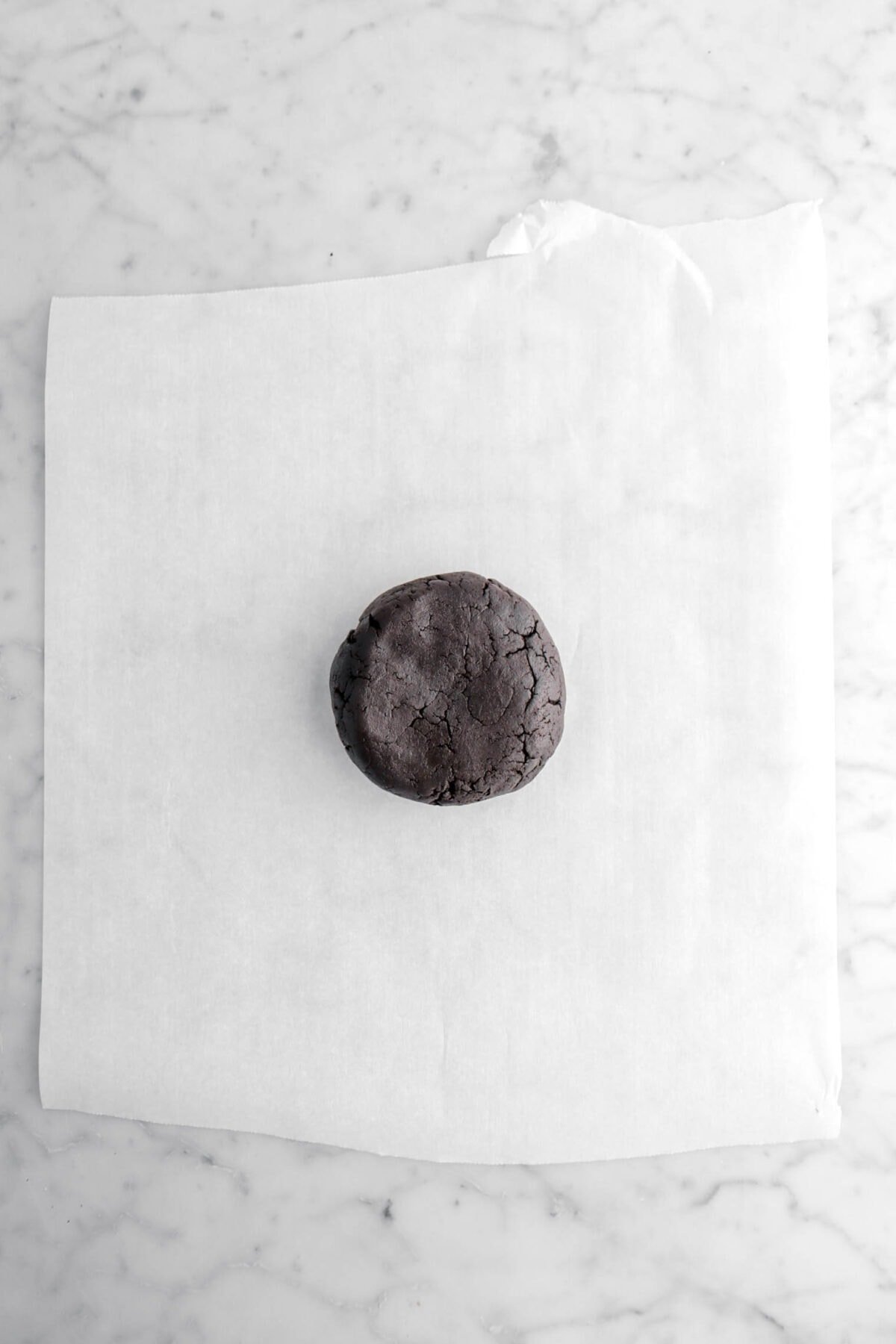 black cookie dough on parchment paper.